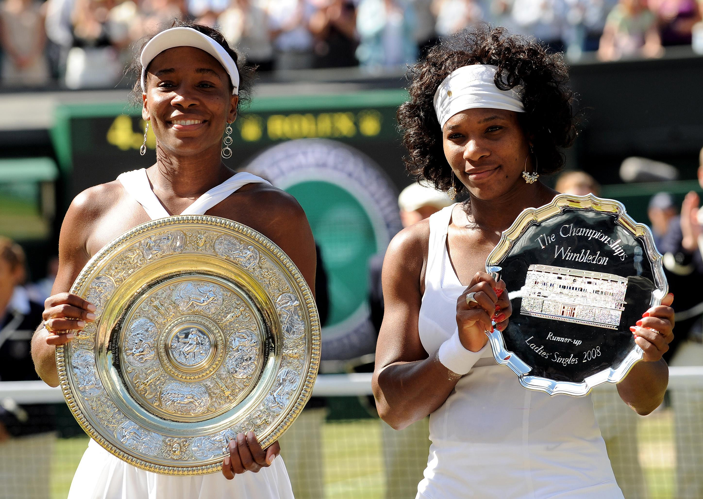 USA's Venus Williams and USA's Serena Williams with their trophies following their Women's Final match during the Wimbledon Championships 2008 at the All England Tennis Club in Wimbledon. (Fiona Hanson—PA Images/Getty Images)