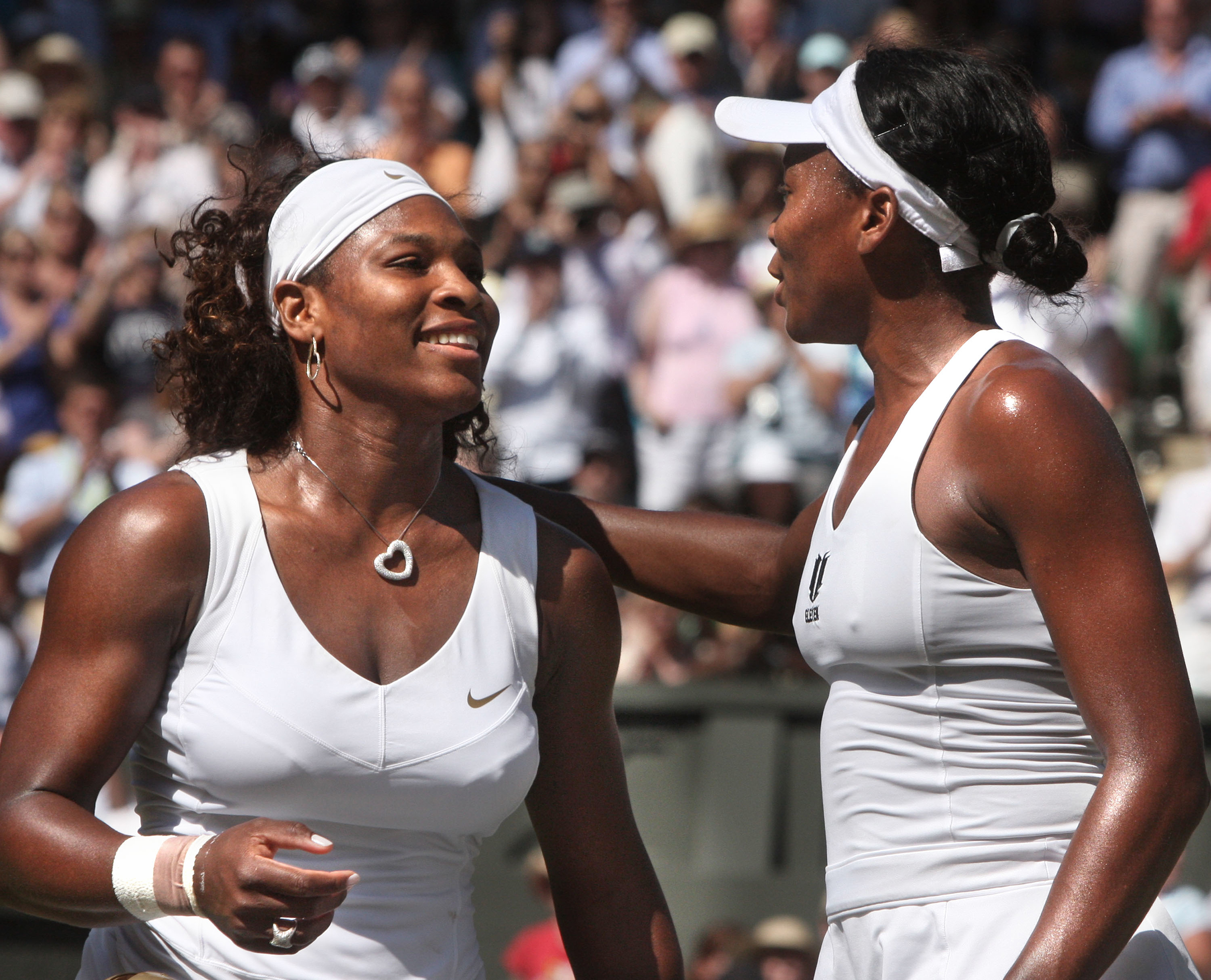 July 4, 2009 Serena Williams her sister Venus meet at the net after Serena defeated Venus 7-6, 6-2 in the final of the Wimbledon Championships at the All England Lawn Tennis Club, Wimbledon, England on Jul, 4 2009. (Cynthia Lum—Icon Sport Media/Corbis/Getty Images)