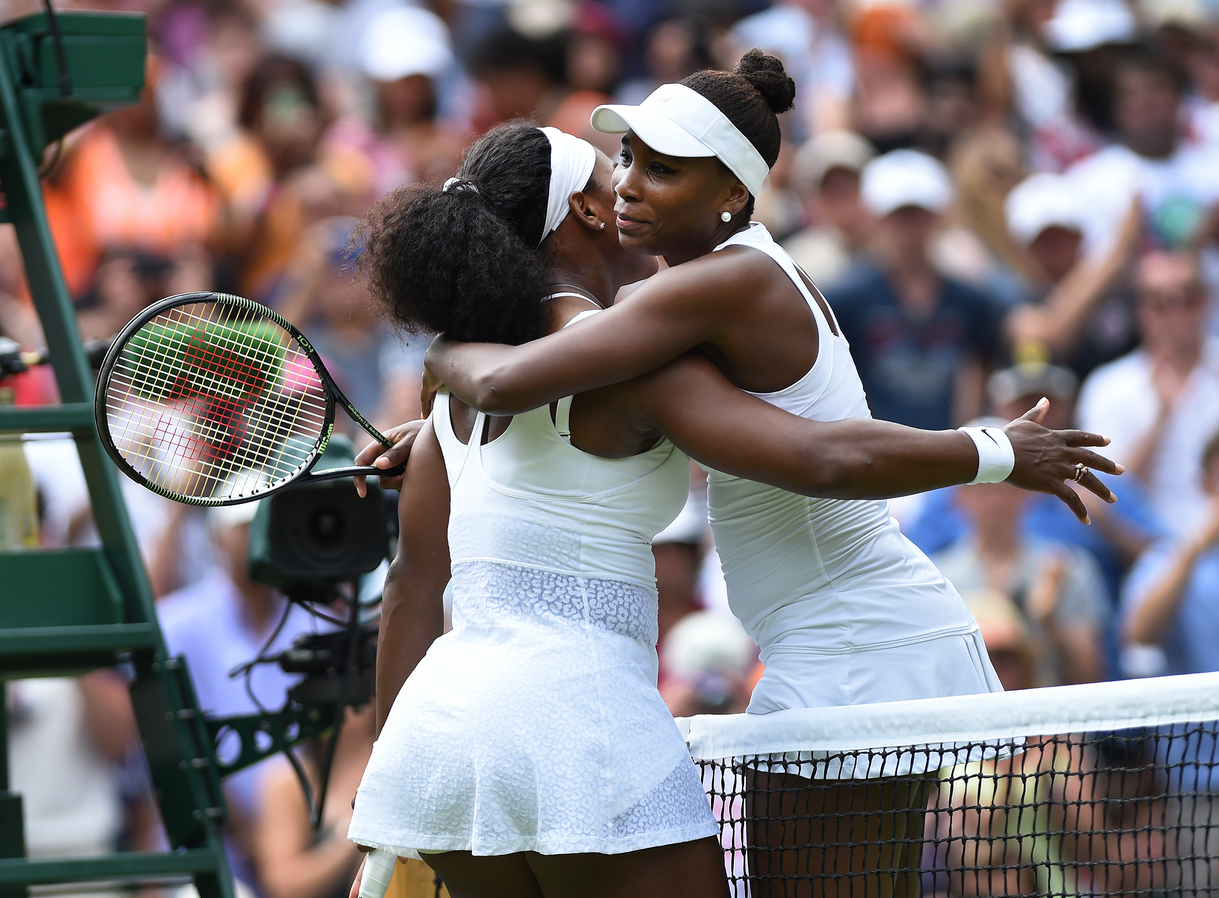 Venus Williams of USA embraces her sister after her fourth round match against Serena Williams of USA on Day Seven of the 2015 Wimbledon Lawn Tennis Championships at the All England Lawn Tennis and Croquet Club in London, UK. (Visionhaus—Corbis/Getty Images)