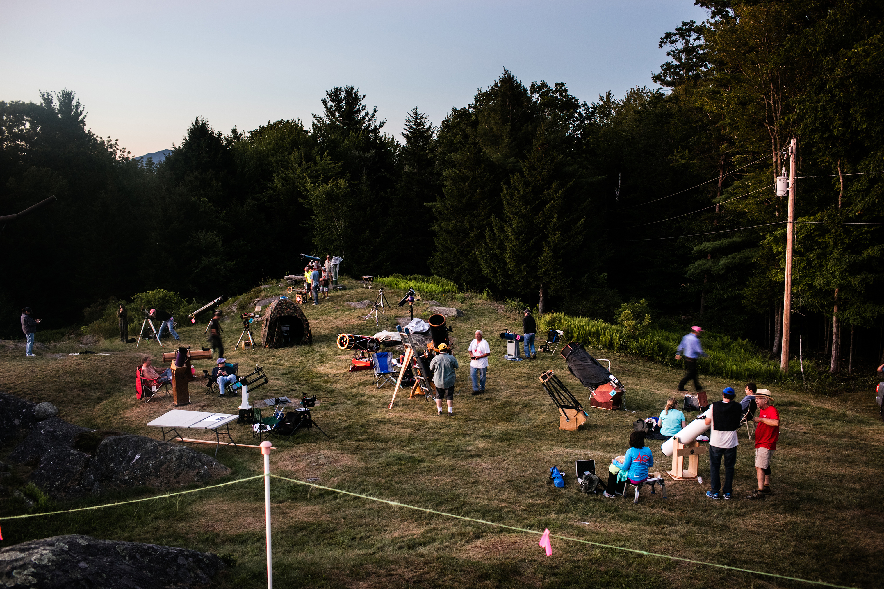 As the sun starts to set, people set up their telescopes, many of which are home-made, on Breezy Hill in Springfield, Vermont. (Robert Ormerod for TIME)