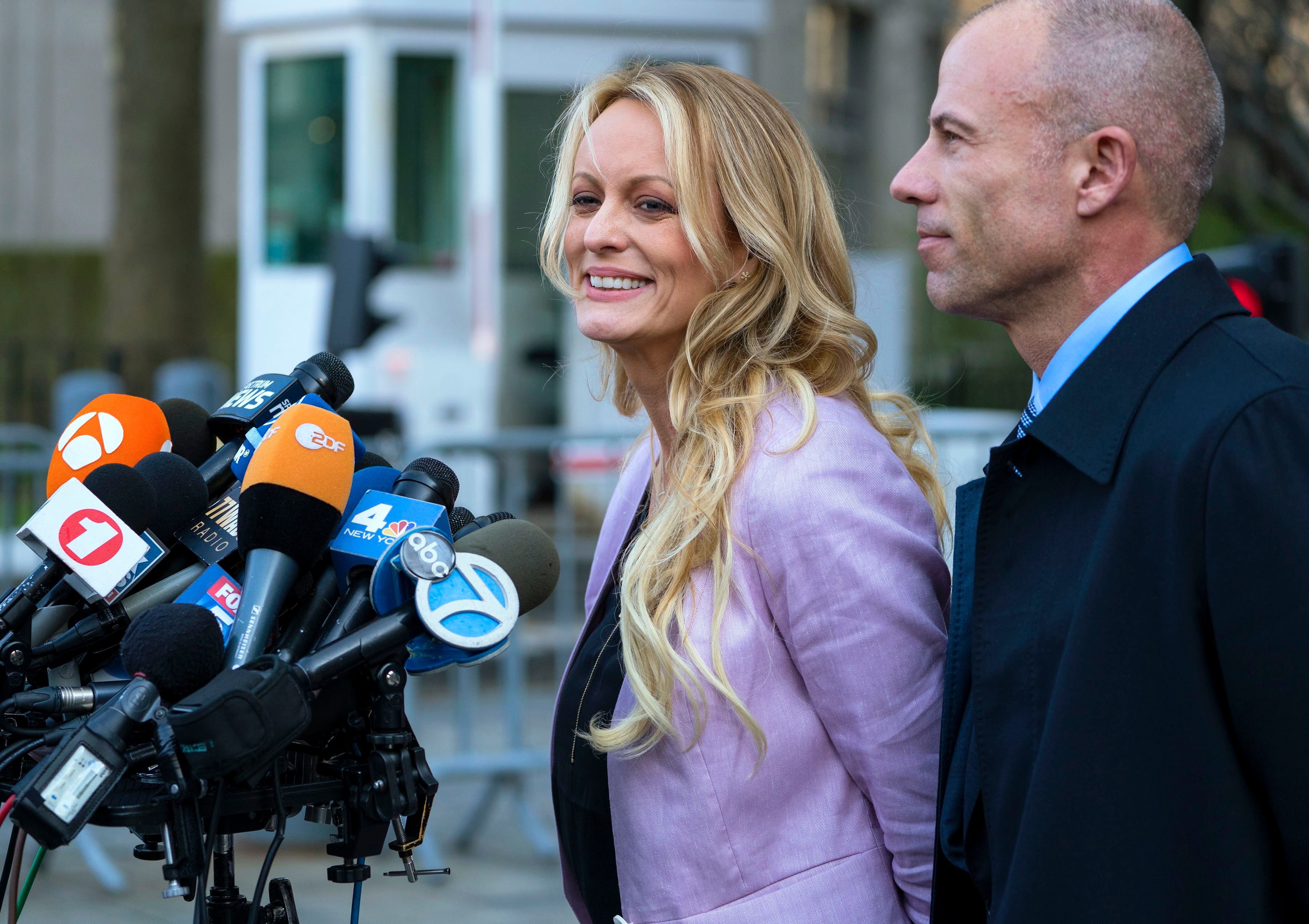 Adult film actress Stormy Daniels speaks to members of the media after a hearing at federal court, in New York, as she is accompanied by her attorney Michael Avenatti on April 16, 2018. (Craig Ruttle—AP—REX—Shutterstock)