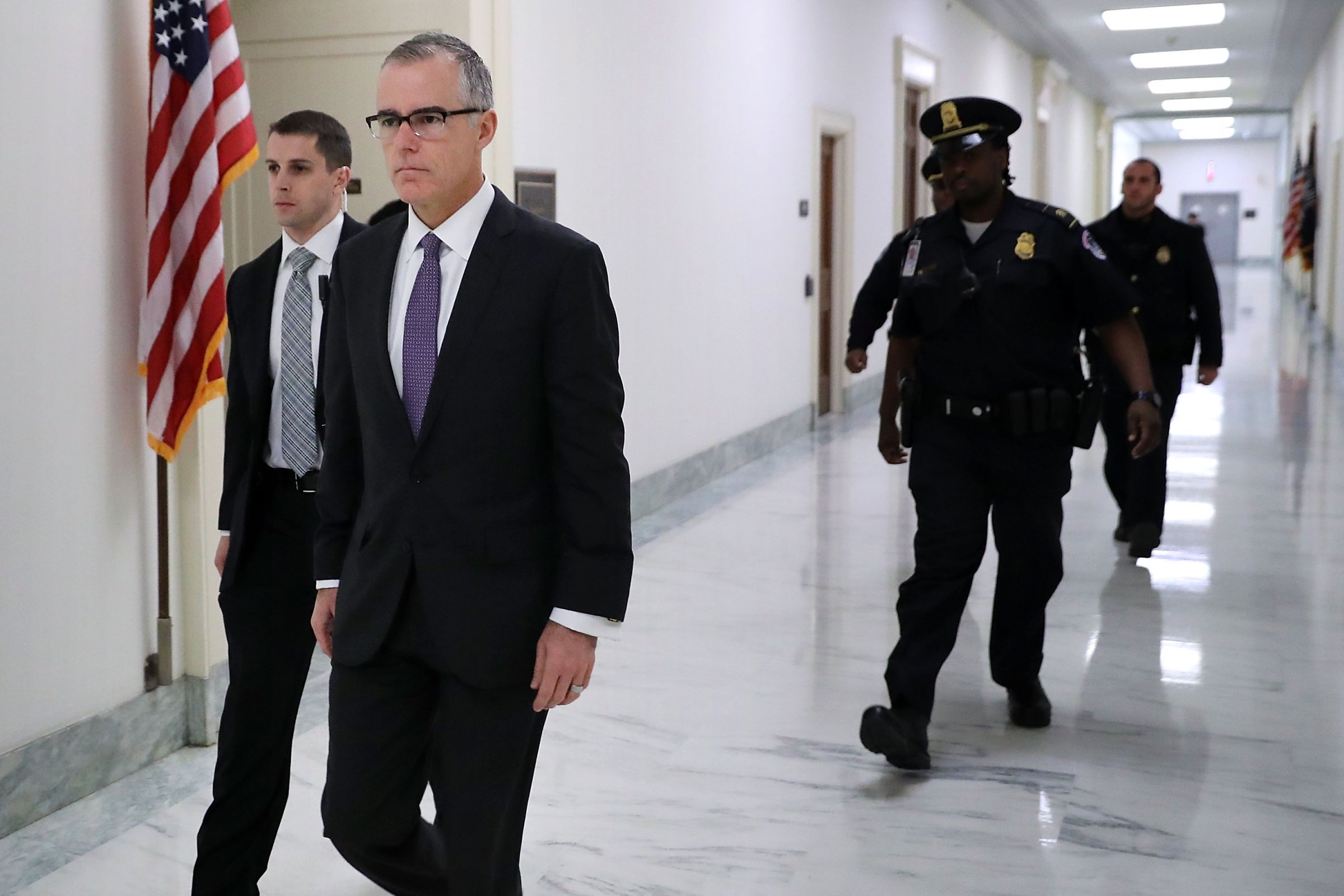 McCabe walking while being escorted by Capitol Police