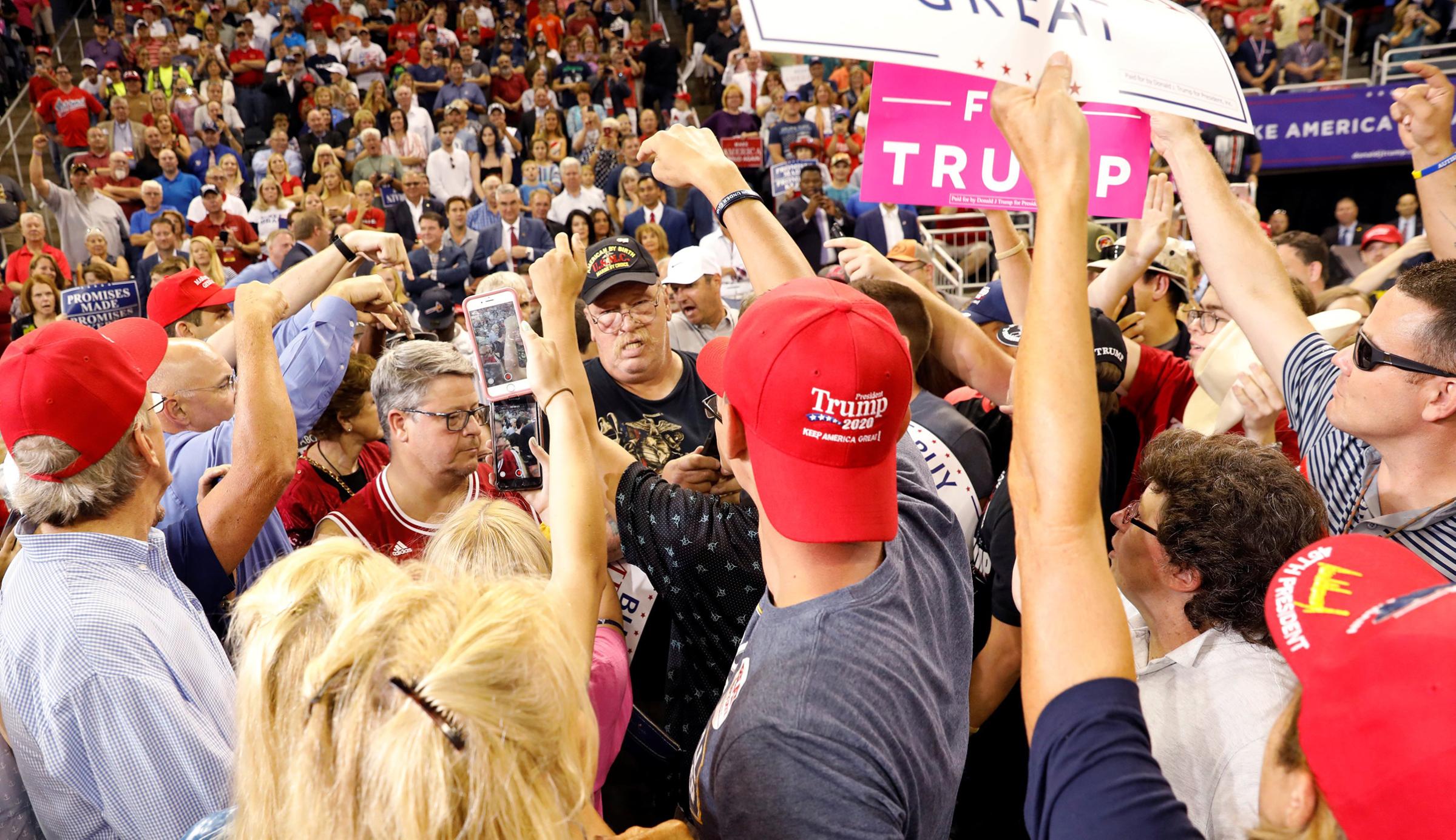 Trump supporters point out a protester to be removed during President Trump's "Make America Great Again" rally in Evansville, Ind, August 30, 2018.