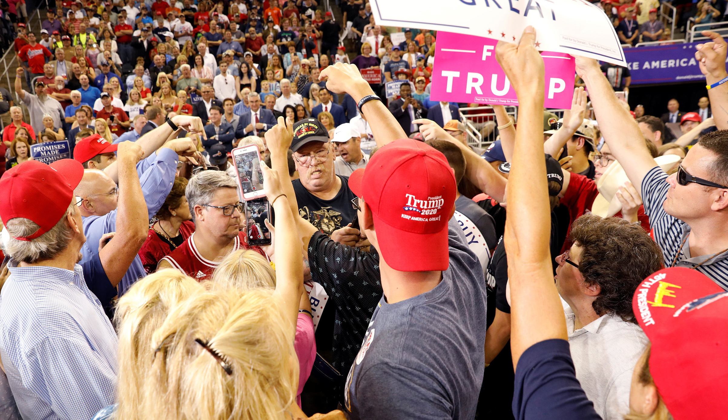 Trump supporters point out a protester to be removed during President Trump's 