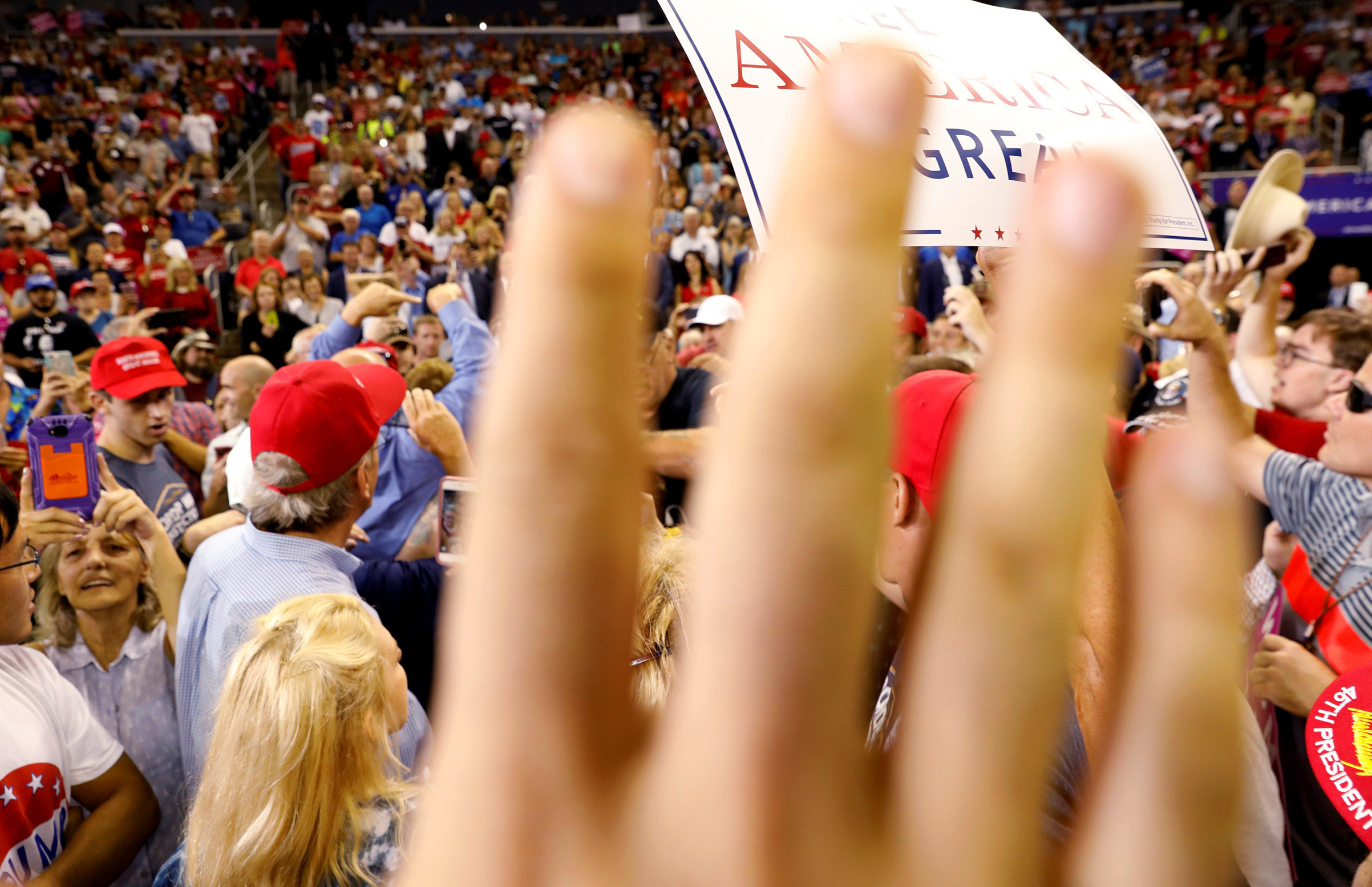 A volunteer for Trump attempts to block the view of protesters a "Make America Great Again" rally in Evansville, Indiana, August 30, 2018. (Kevin Lamarque—Reuters)