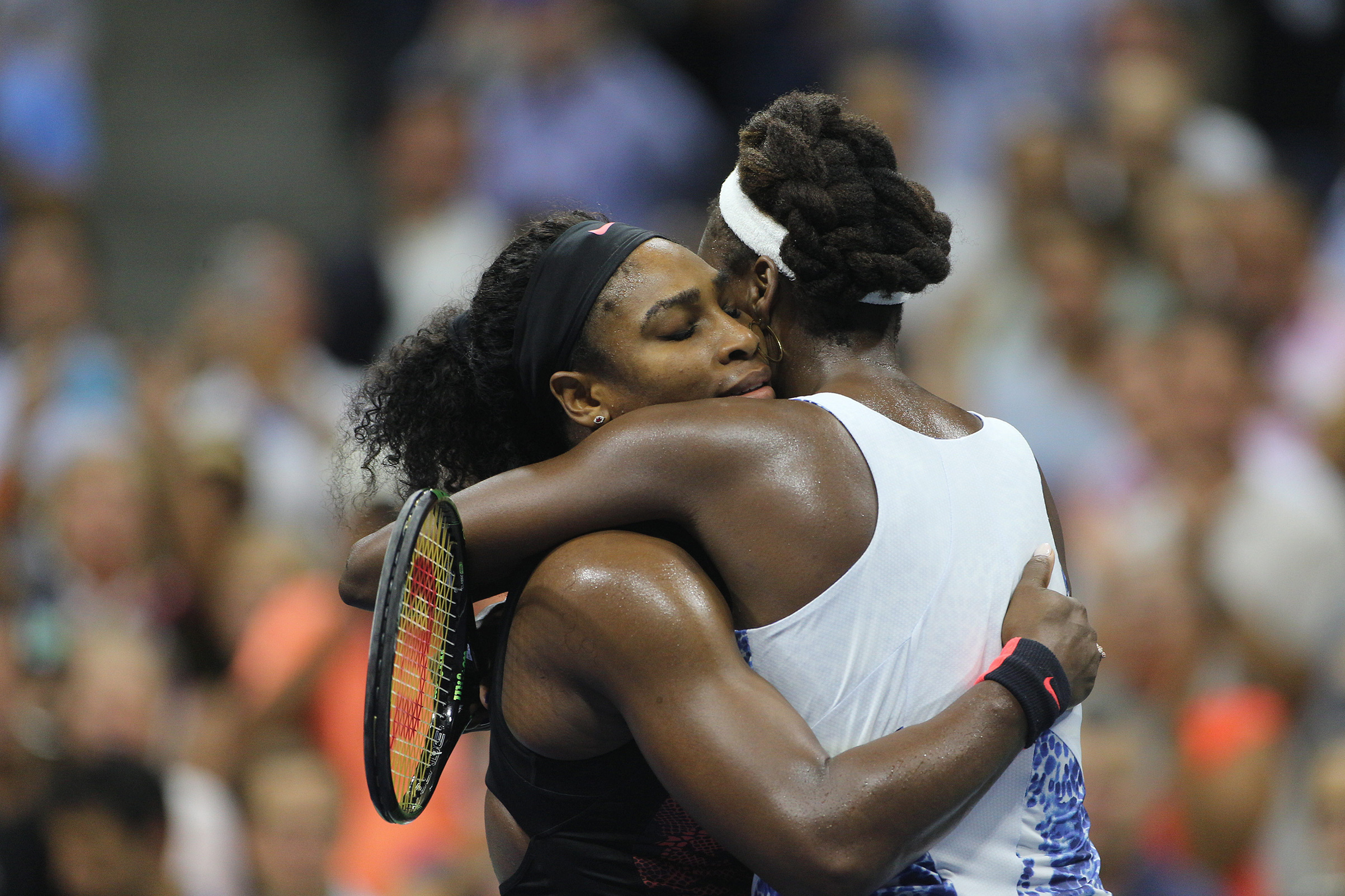 Serena Williams, USA and sister Venus Williams, USA, embrace after in their Women's Singles Quarterfinals match won by Serena during the US Open Tennis Tournament, Flushing, New York, USA on Sept 8, 2015. (Tim Clayton—Corbis/Getty Images)