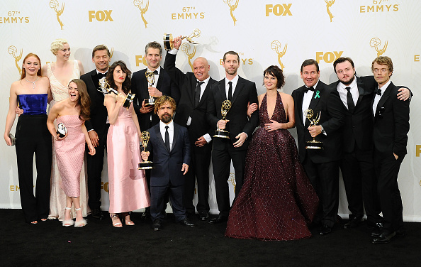 The cast and writers of Game of Thrones pose in the press room at the 2015 Emmys