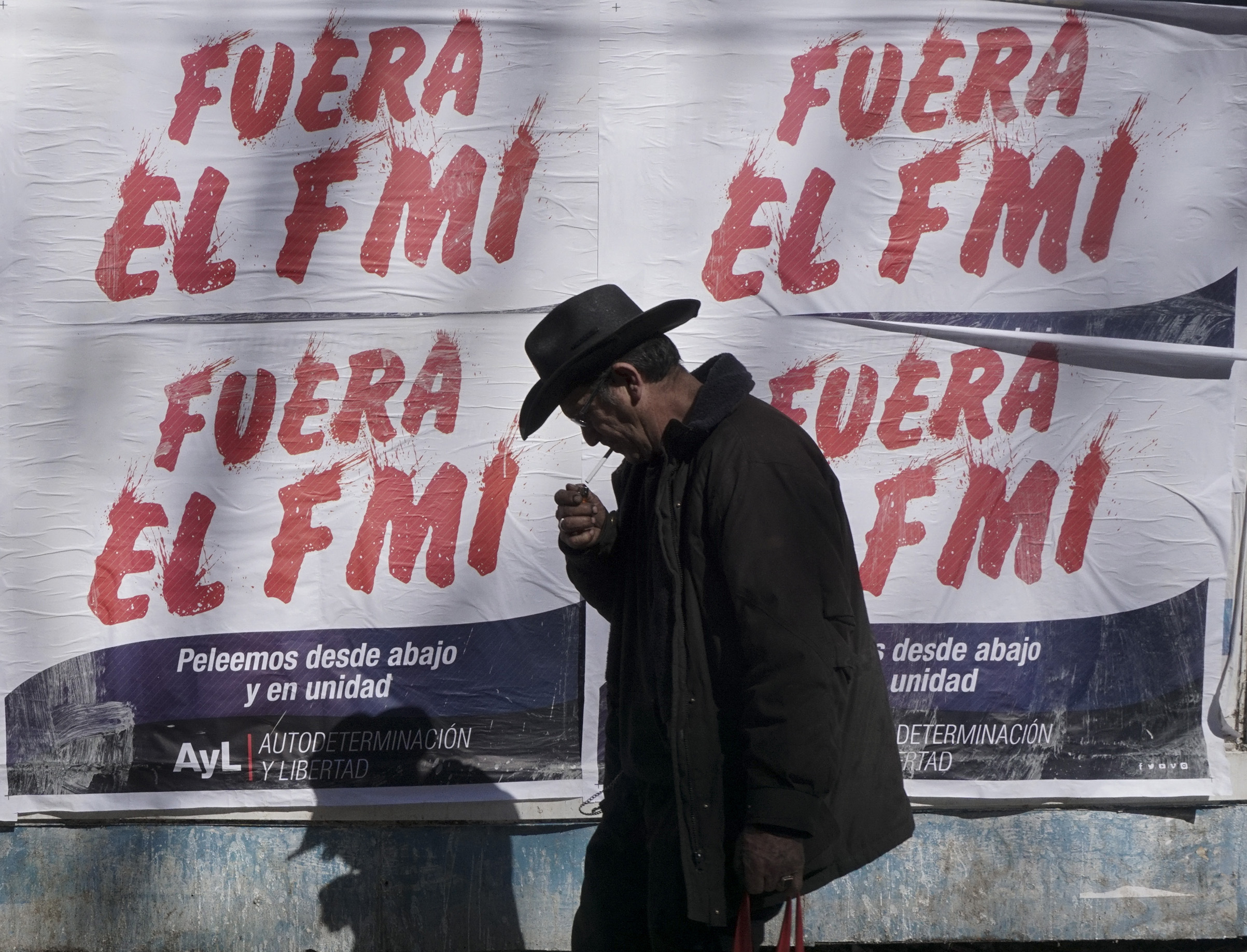 A man walks past posters rejecting the government's negotiations with the International Monetary Fund (IMF), in Buenos Aires, on September 4, 2018. (Eitan Abramovich—AFP/Getty Images)