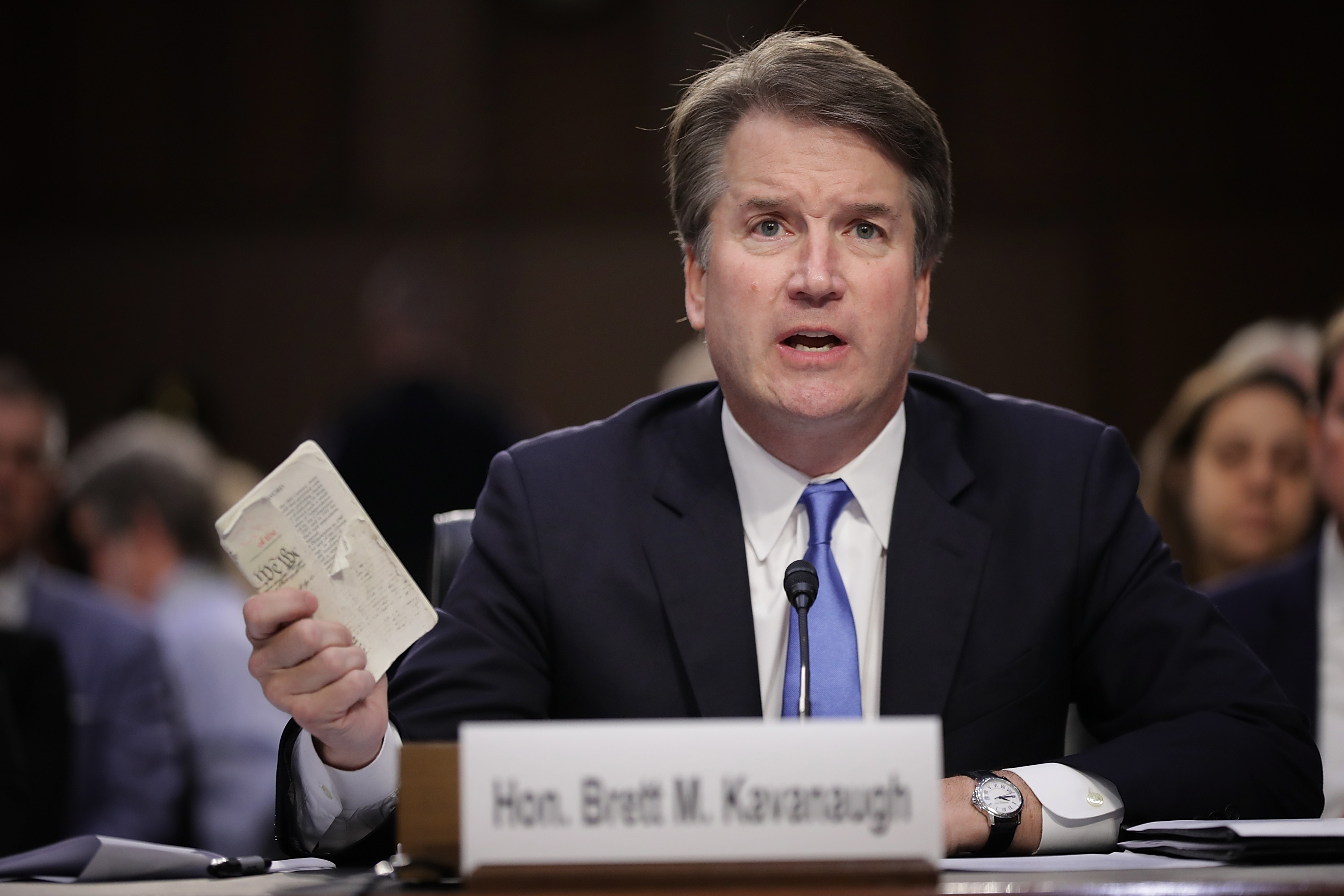 Supreme Court nominee Judge Brett Kavanaugh holds up a small copy of the U.S. Constitution while answering questions before the Senate Judiciary Committee during the second day of his Supreme Court confirmation hearing on Capitol Hill September 5, 2018 in Washington, D.C. (Chip Somodevilla—Getty Images)