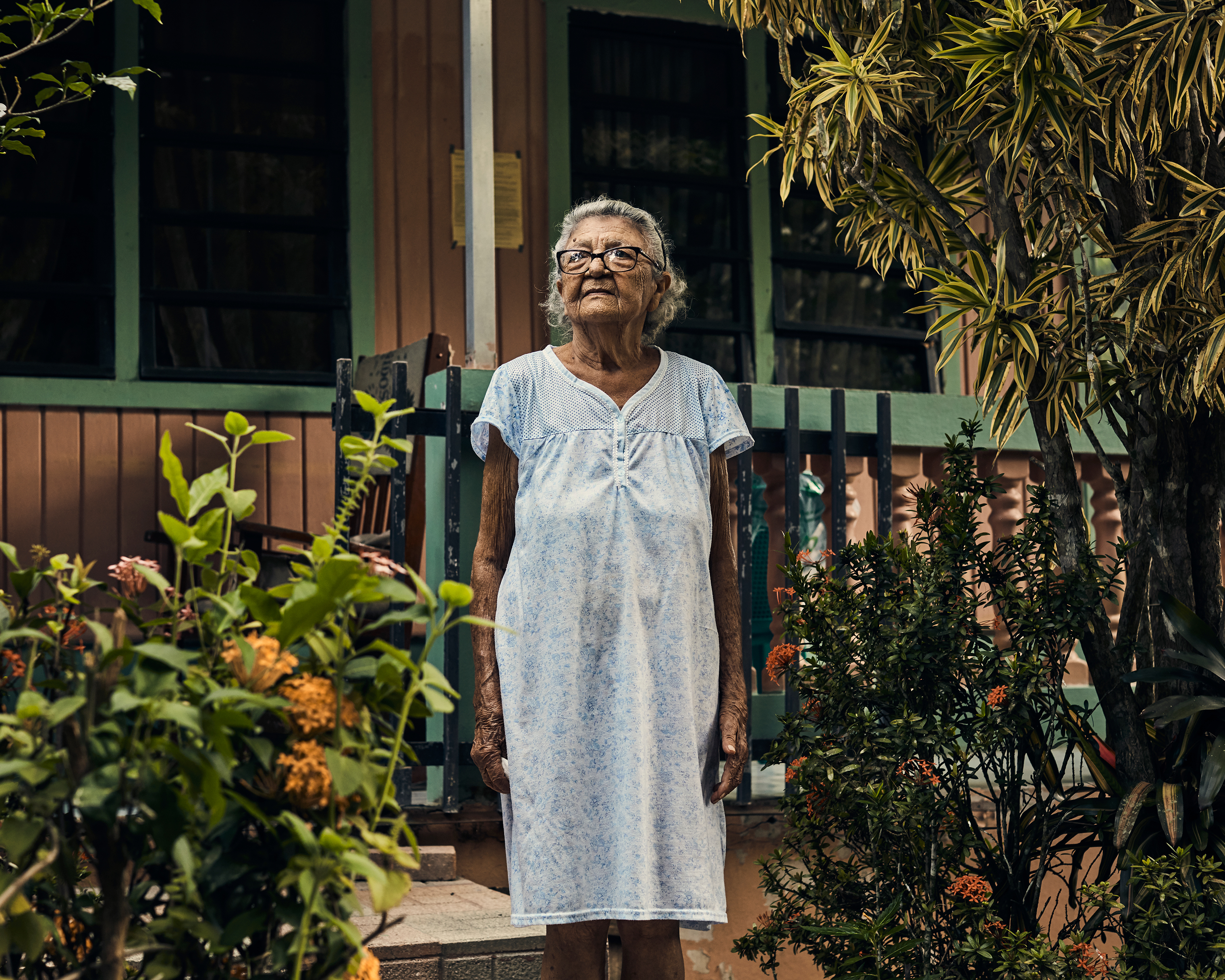 Magdalena Flores poses in front of her home in Utuado on Aug. 31. Her daughter, Maribel, died in the aftermath of the storm from asthma complications. (Christopher Gregory for TIME)