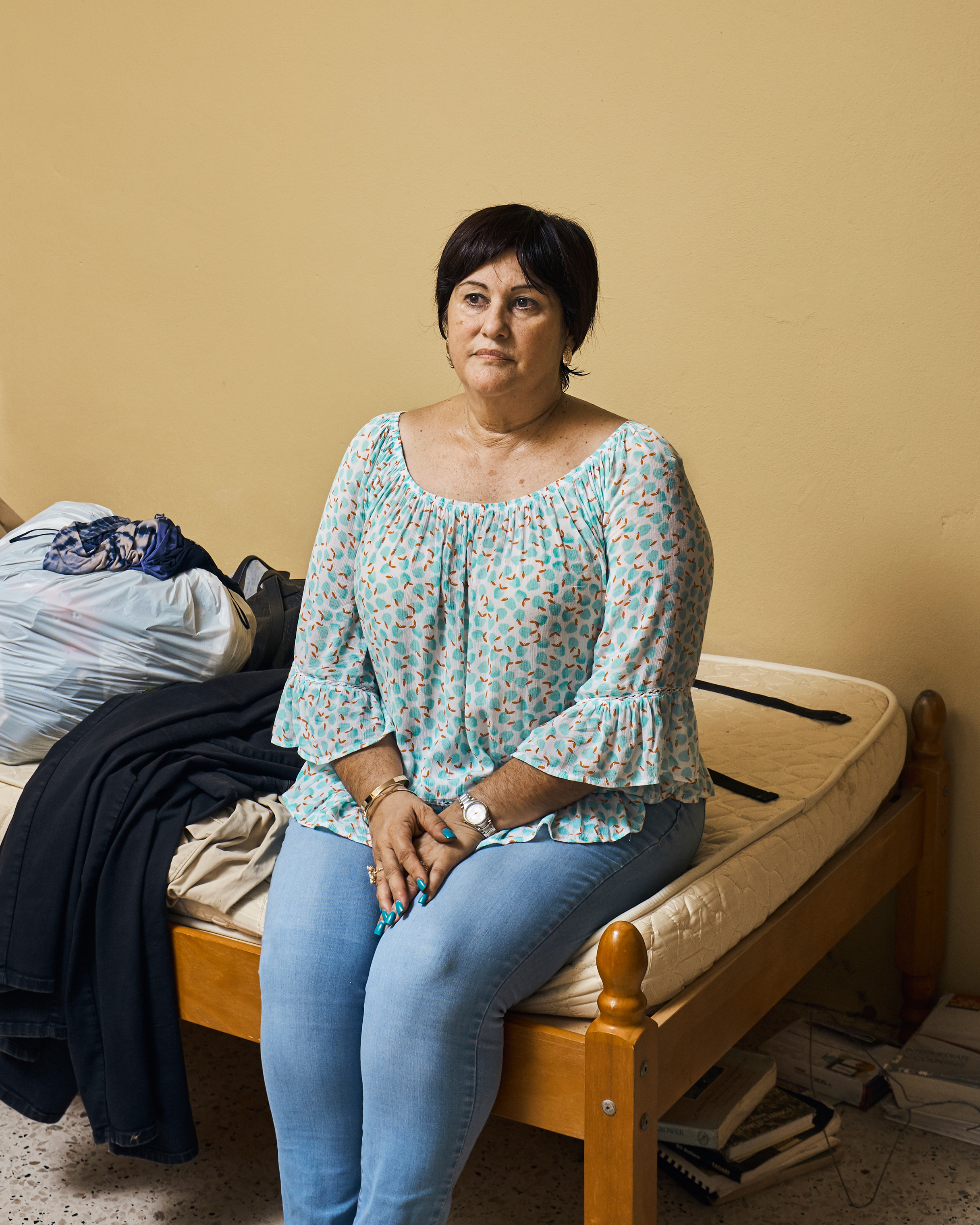 Zilma Maldonado poses in her son Miguel García's room in Utuado on Aug. 31. He and his brother left after the hurricane. (Christopher Gregory for TIME)