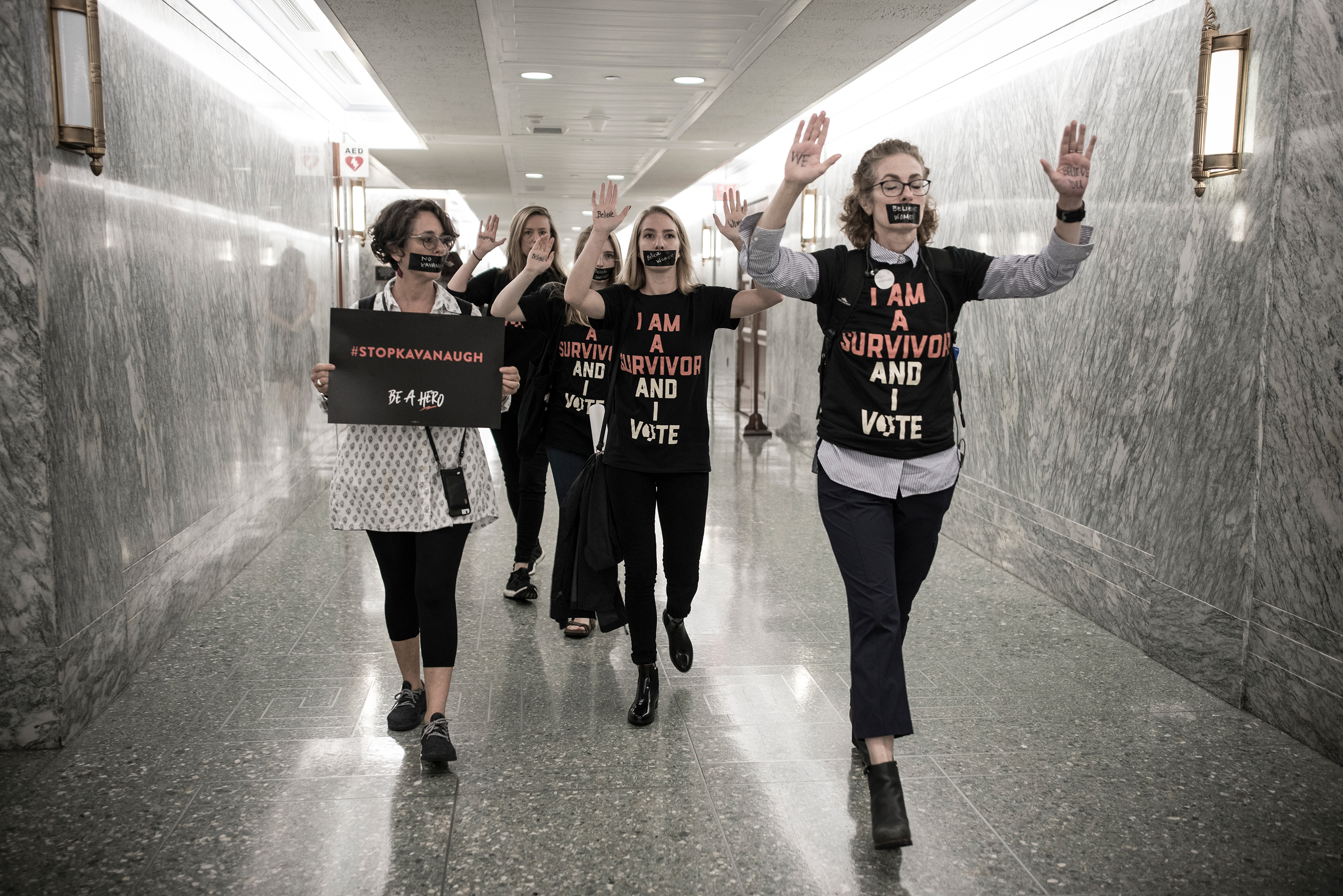 Protesters walk through the hallway of the Dirksen Senate Office Building on Sept. 27. (David Butow—Redux for TIME)