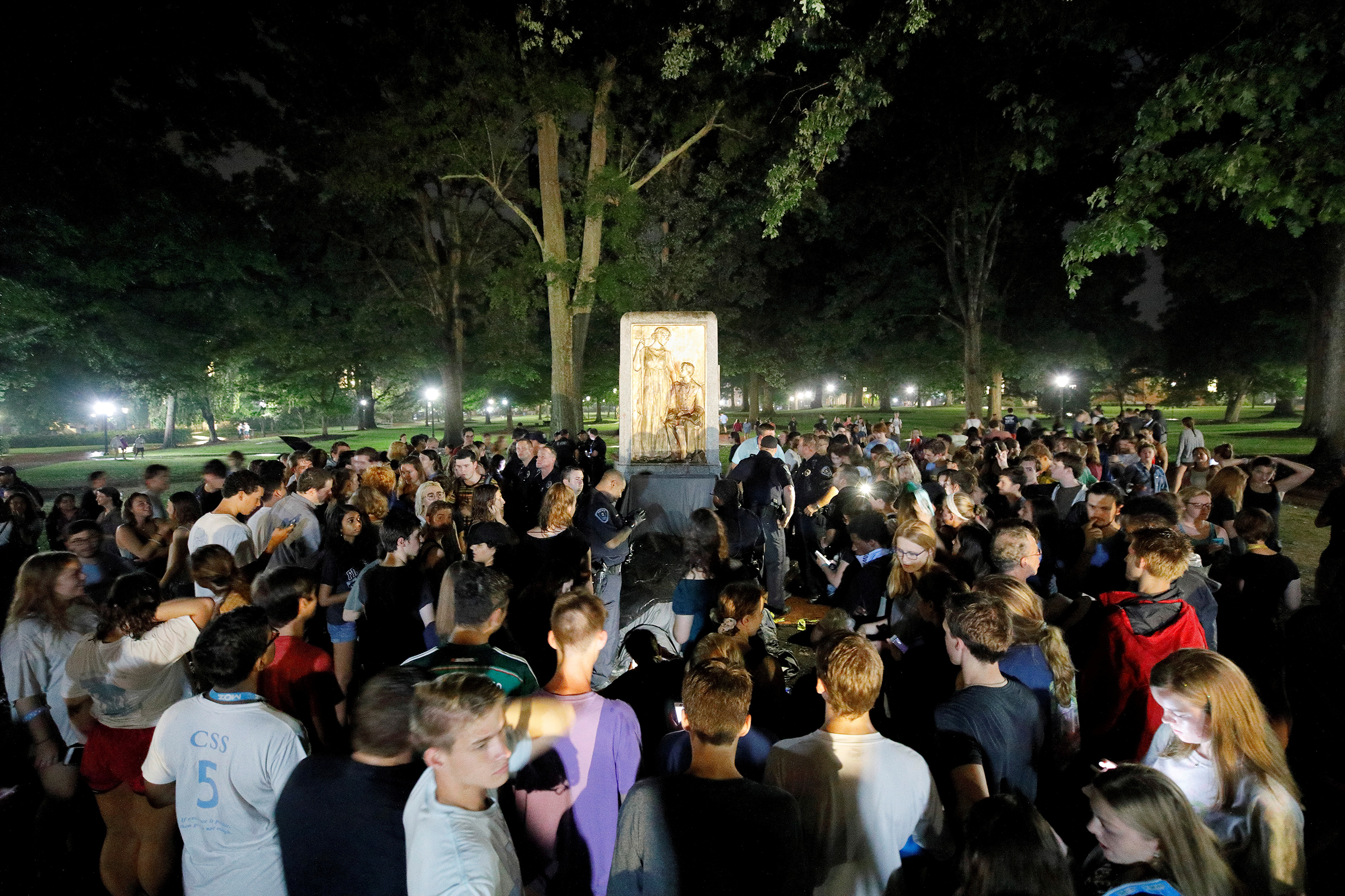 Students and protesters surround the plinth where the toppled statue of a Confederate soldier nicknamed Silent Sam once stood on the University of North Carolina campus, after a demonstration for its removal in Chapel Hill, North Carolina, on Aug. 20, 2018. (Jonathan Drake&mdash;REUTERS)