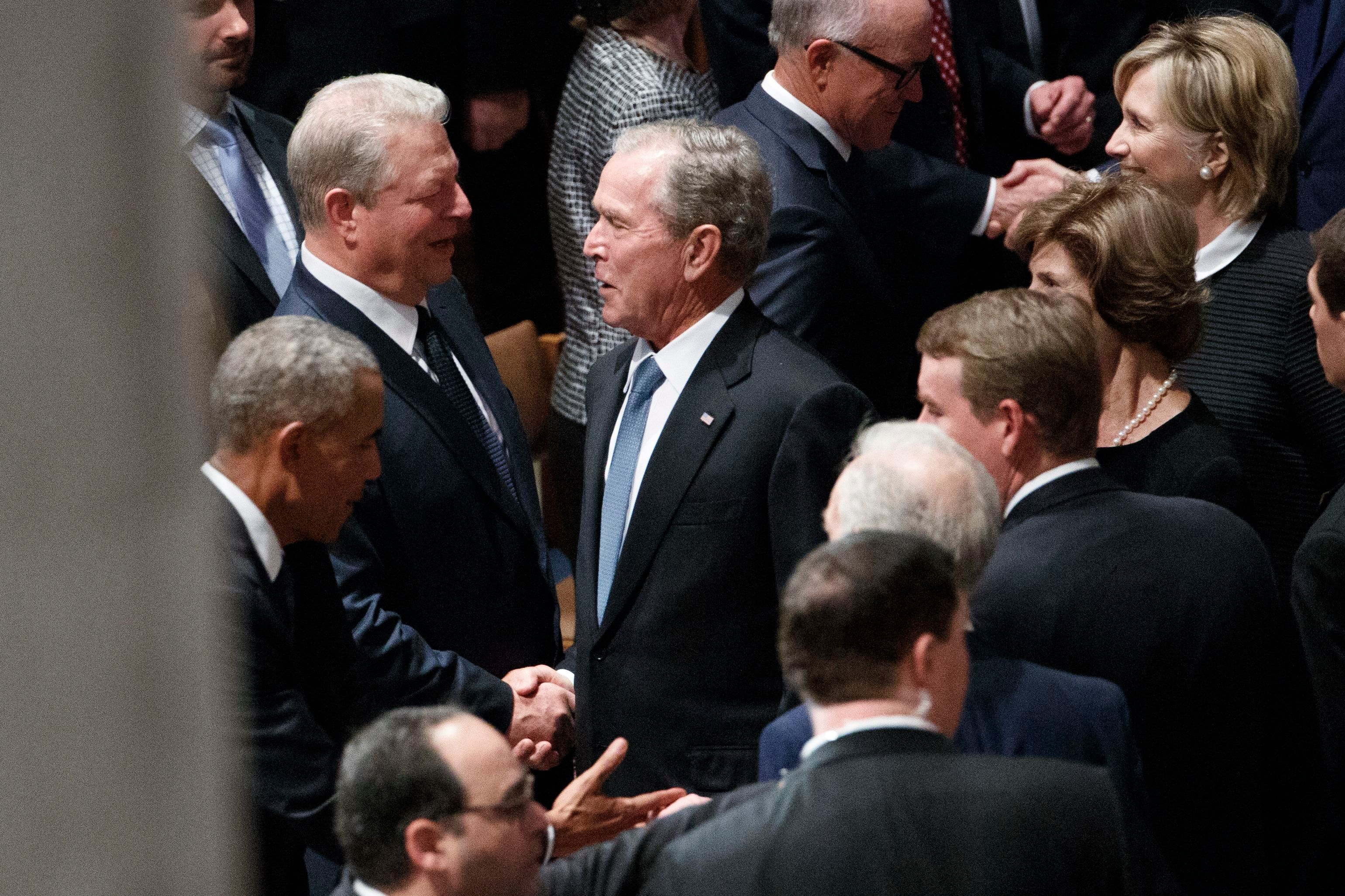 Former US President George W. Bush and former Vice President Al Gore – bitter political rivals – shake hands and John McCain's funeral at Washington National Cathedral Saturday, Sept. 1, 2018. (SHAWN THEW/EPA-EFE/REX/Shutterstock)