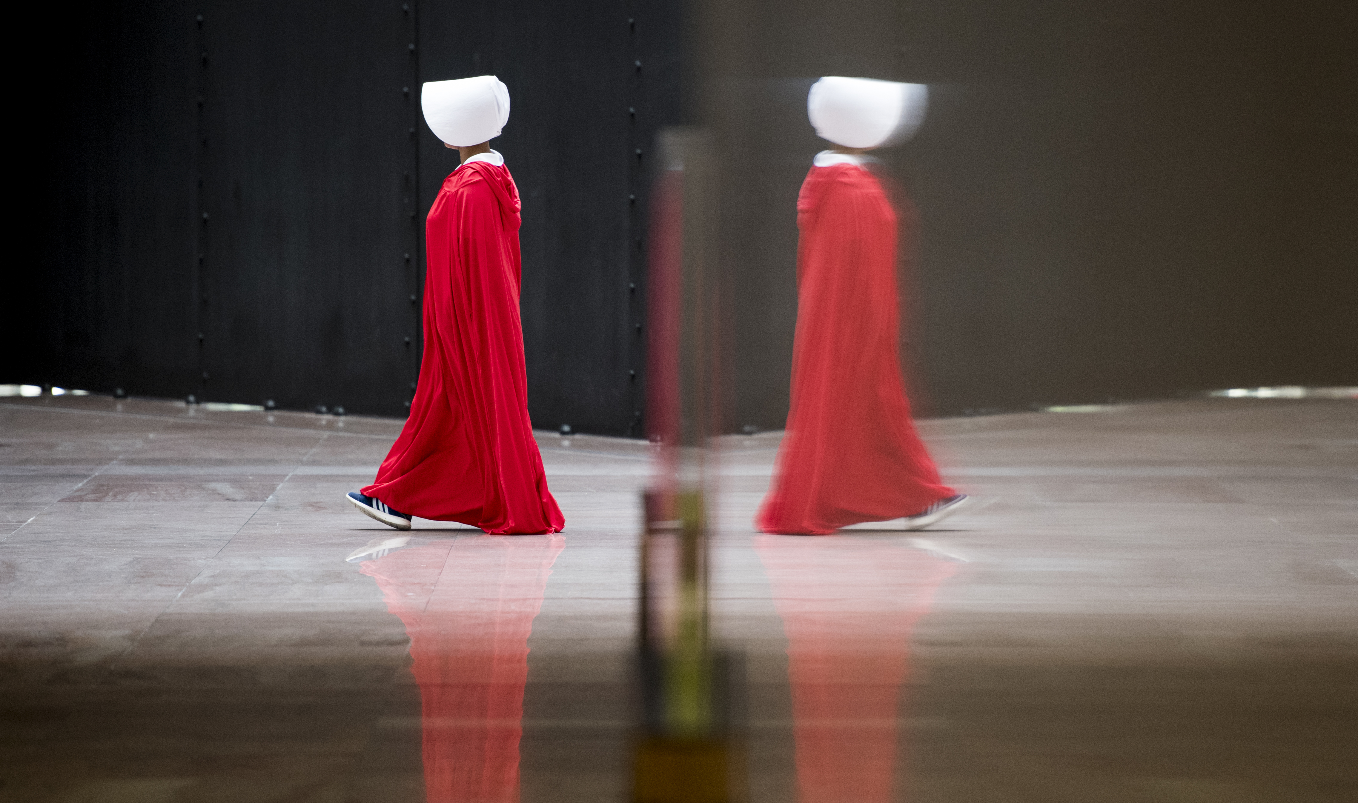 SEPT. 4: One of a dozen protesters dressed in The Handmaid's Tale costumes walks in a circle in the atrium of the Hart Senate Office Building during the confirmation hearing of Brett Kavanaugh (Bill Clark&mdash;CQ-Roll Call,Inc.)