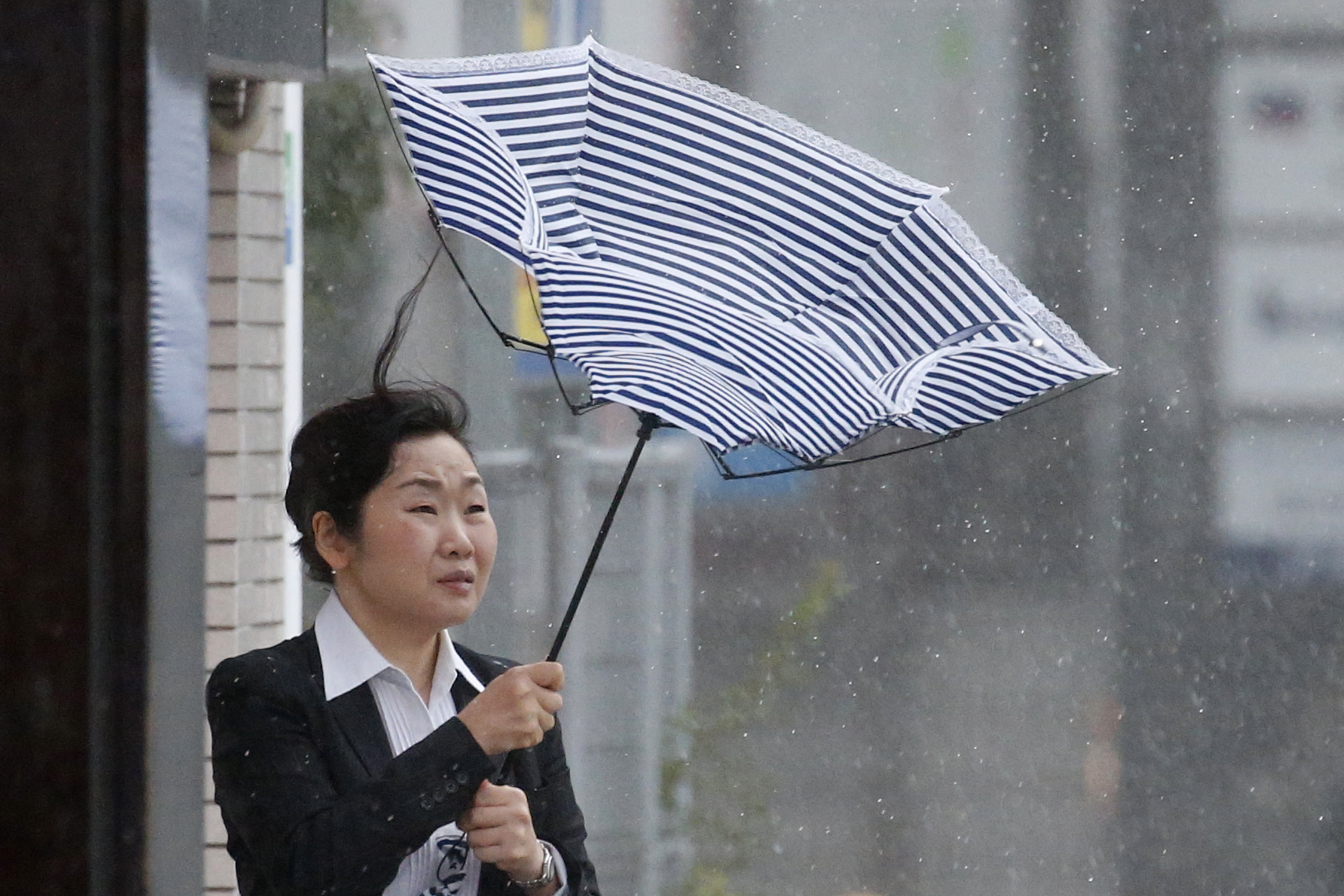 A woman using an umbrella struggles against strong wind and rain caused by Typhoon Jebi, in Tokyo, Japan, Sept. 4, 2018. (Hitoshi Yamada—NurPhoto/Getty Images)