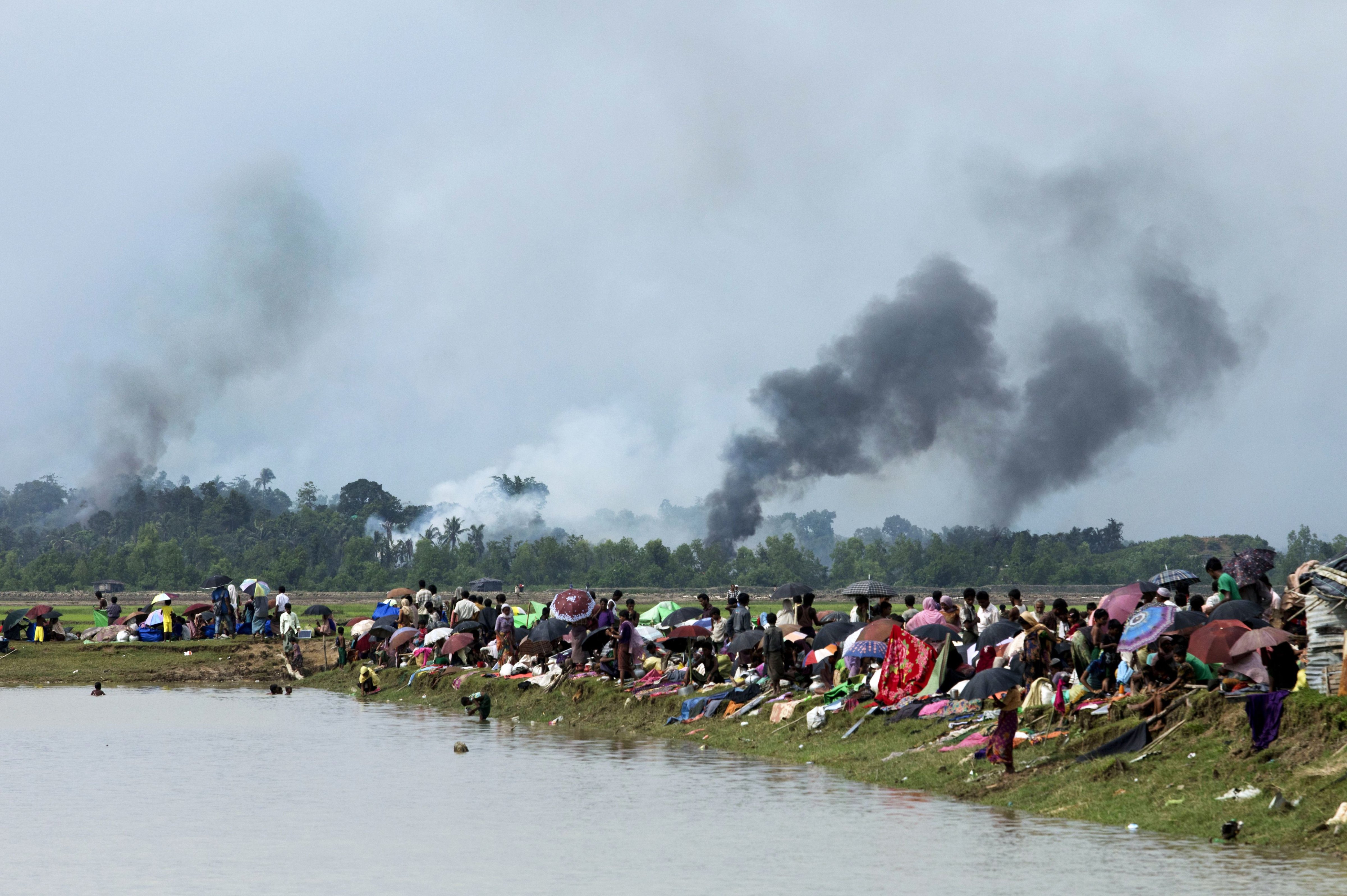 Smoke billows above what is believed to be a burning village in Myanmar's Rakhine state as members of the Rohingya Muslim minority take shelter in Ukhia, Bangladesh on Sept. 4, 2017. (K.M. Asad—AFP/Getty Images)