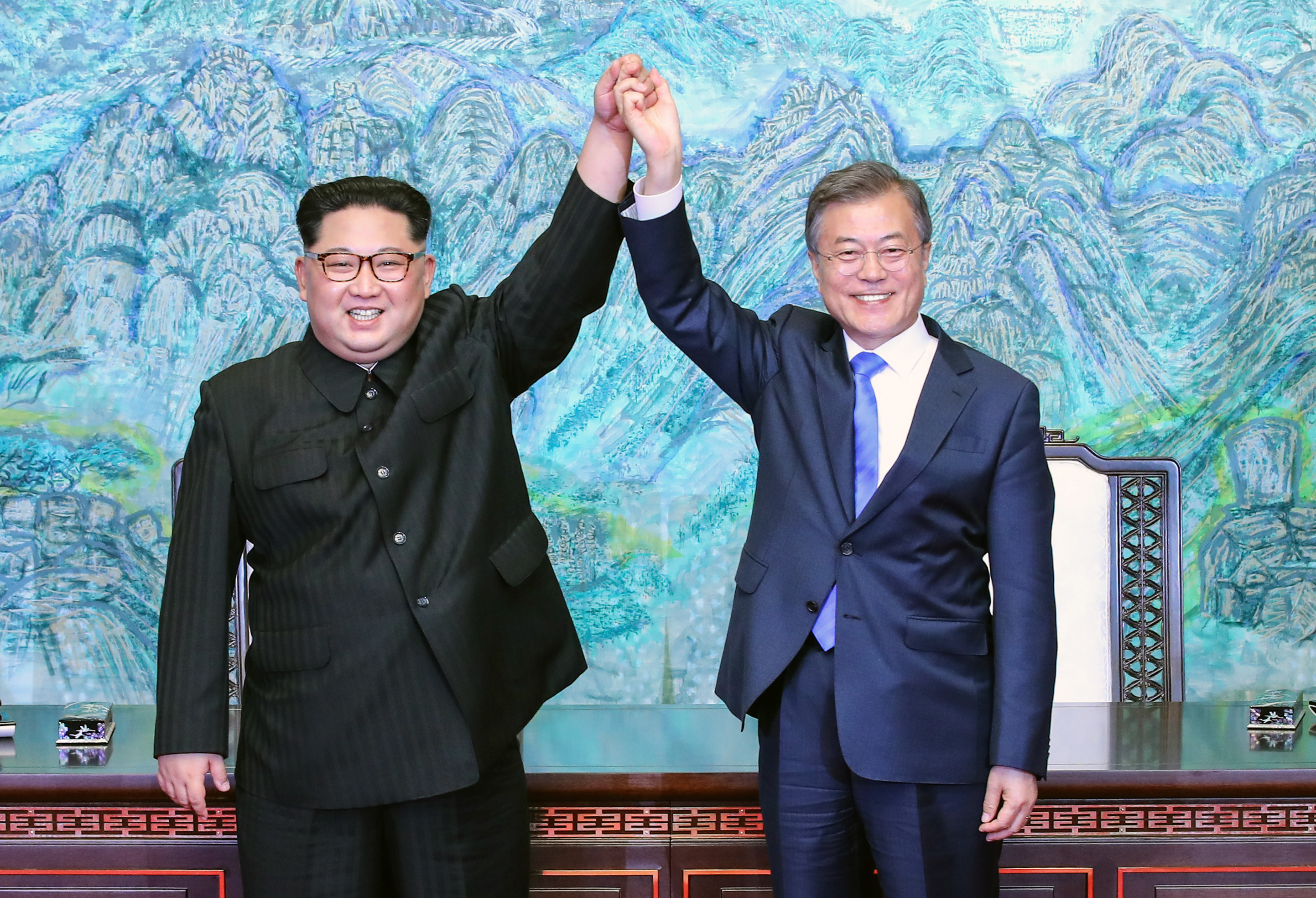 North Korean leader Kim Jong Un (L) and South Korean President Moon Jae-in (R) pose for photographs after signing the Panmunjom Declaration for Peace, Prosperity and Unification of the Korean Peninsula during the Inter-Korean Summit on April 27, 2018. (—Getty Images)