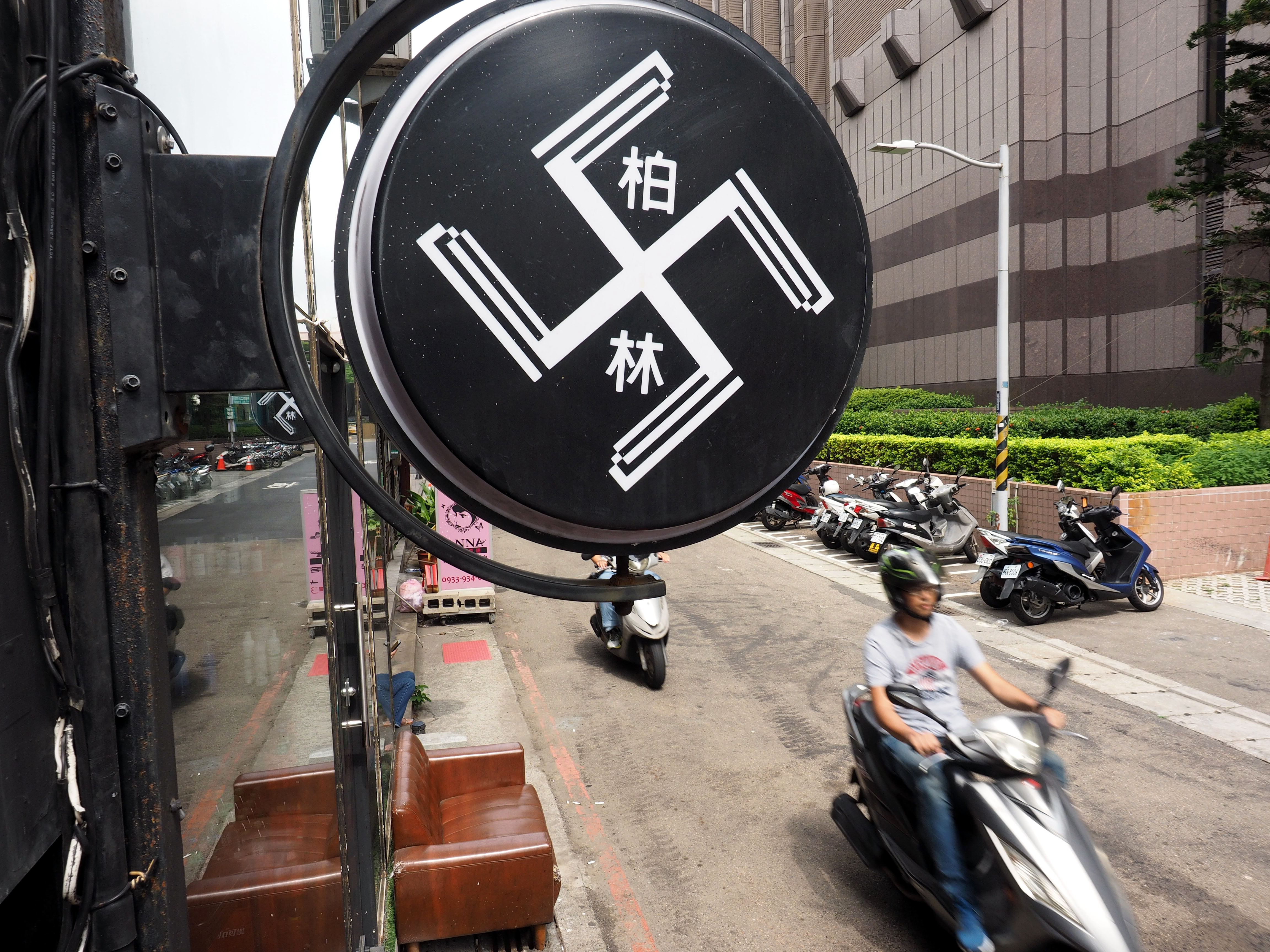 Two signs resembling a swastika hang outside Berlin Hair Salon in Hsinchu City, Taiwan, on Sept. 18, 2018. (David Chang—EPA/EFE)