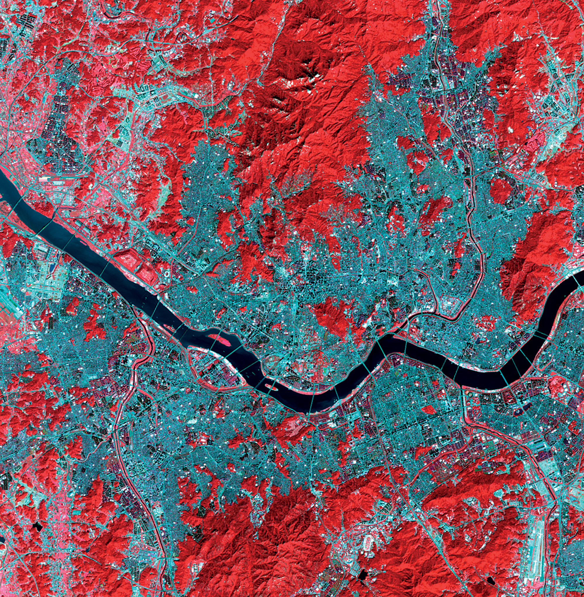 <strong>Seoul, Republic of Korea</strong> <em>1:148,000</em> Twenty-seven bridges span the Han River in the center of Seoul (pictured in dark blue), stitching together the two halves of the city and acting as networks between communities on opposite sides of the river. (Landsat OLI/TIRS)