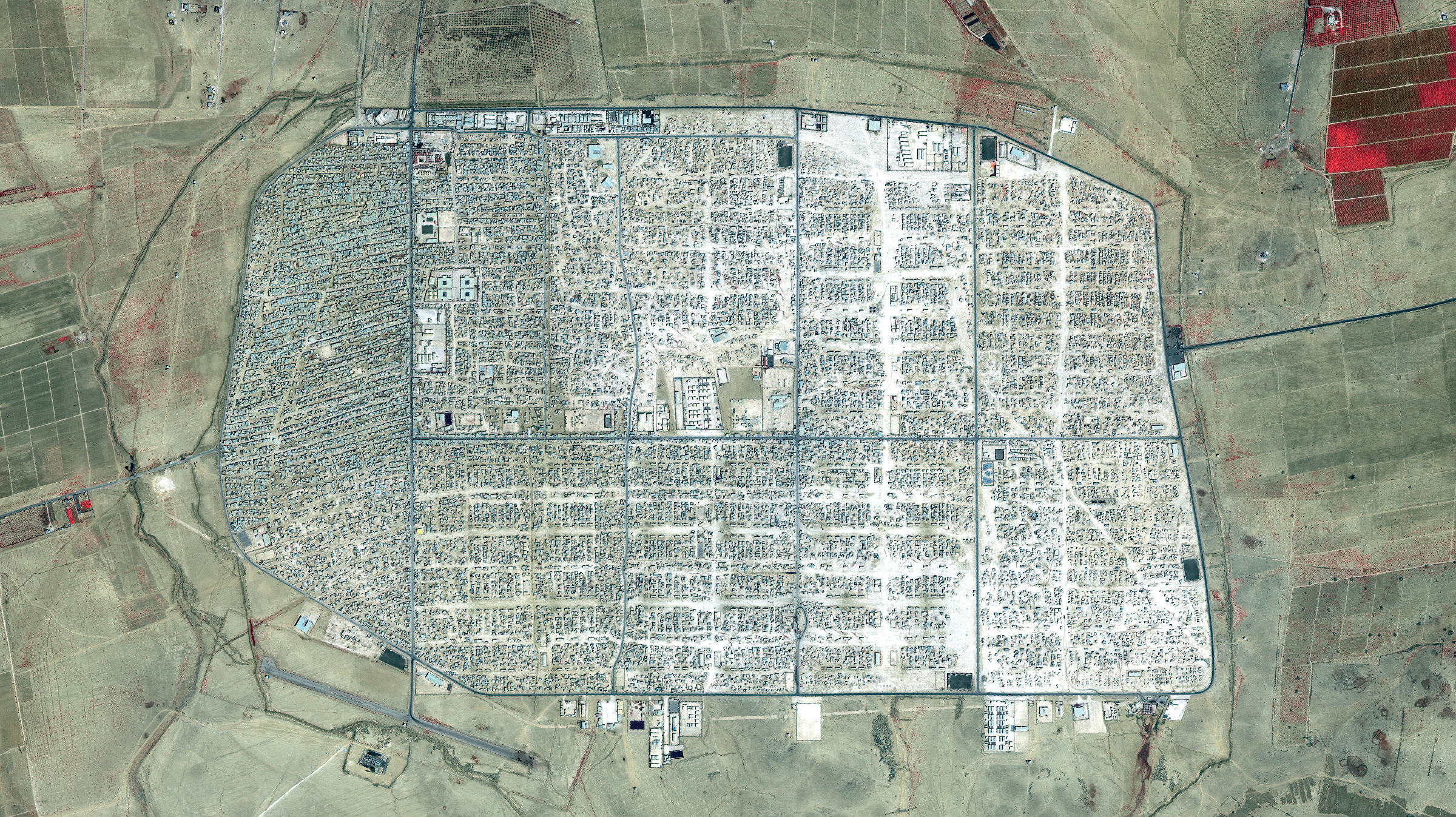 <strong>Zaatari, Jordan</strong> <em>1:25,000</em> Home to about 80,000 Syrian refugees, Zaatari is the largest refugee camp in the Middle East, now functioning as an informal city for its residents. Globally, the number of displaced people reached an unprecedented record in 2015, exceeding 65 million, more than the populations of Canada, Australia and New Zealand combined. (QuickBird, Satellite image courtesy of DigitalGlobe (www.digitalglobe.com), Inc.)