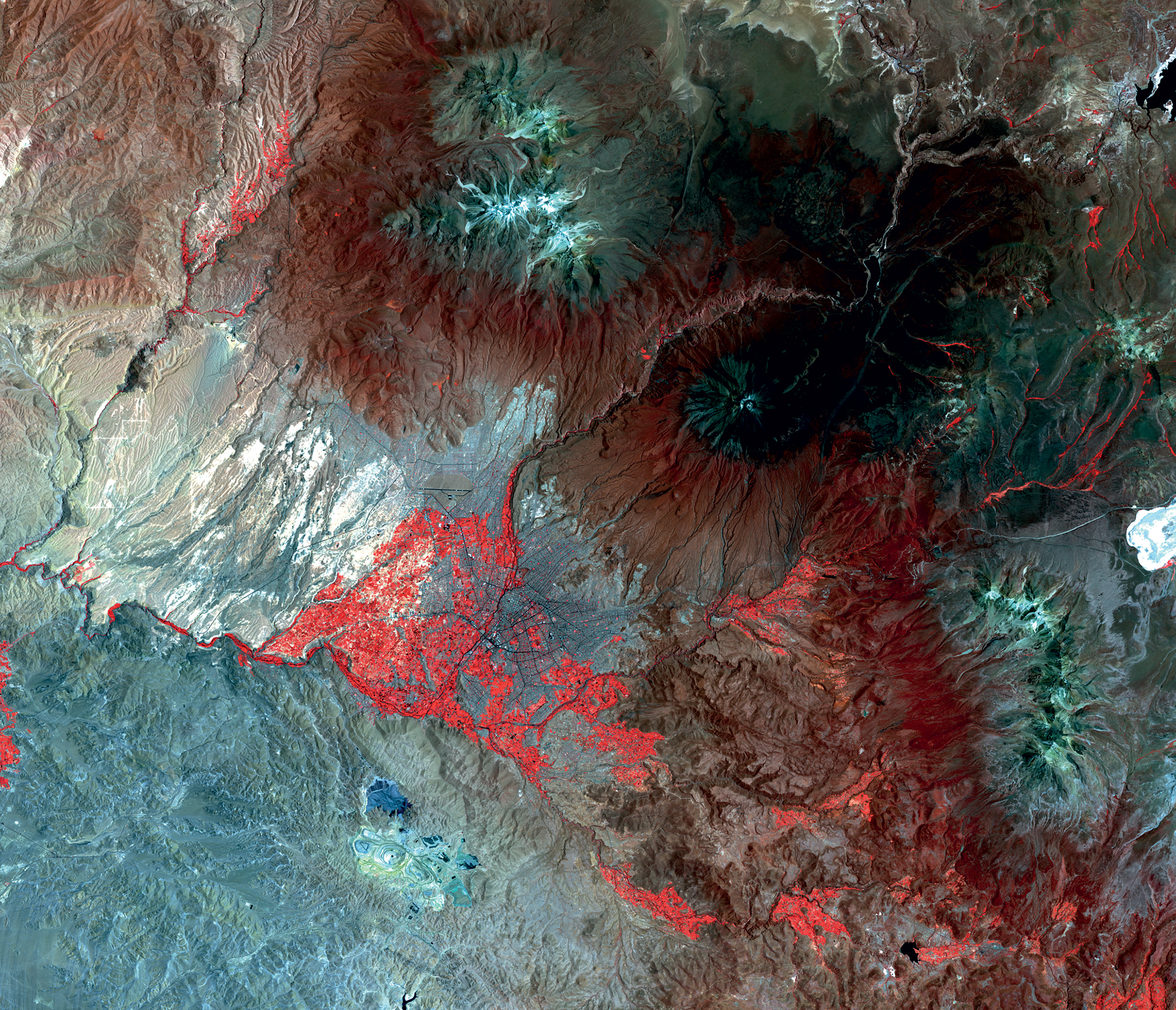 <strong>Arequipa, Peru</strong> <em>1:325,000</em> Mina Cerro Verde is an open-pit copper and molybdenum mine shown in blue in the bottom left of the image, just south of the city. The mine, which has a symbiotic relationship with the city, has been expanded in recent years and operates the city’s first wastewater treatment plant. (Landsat OLI/TIRS)