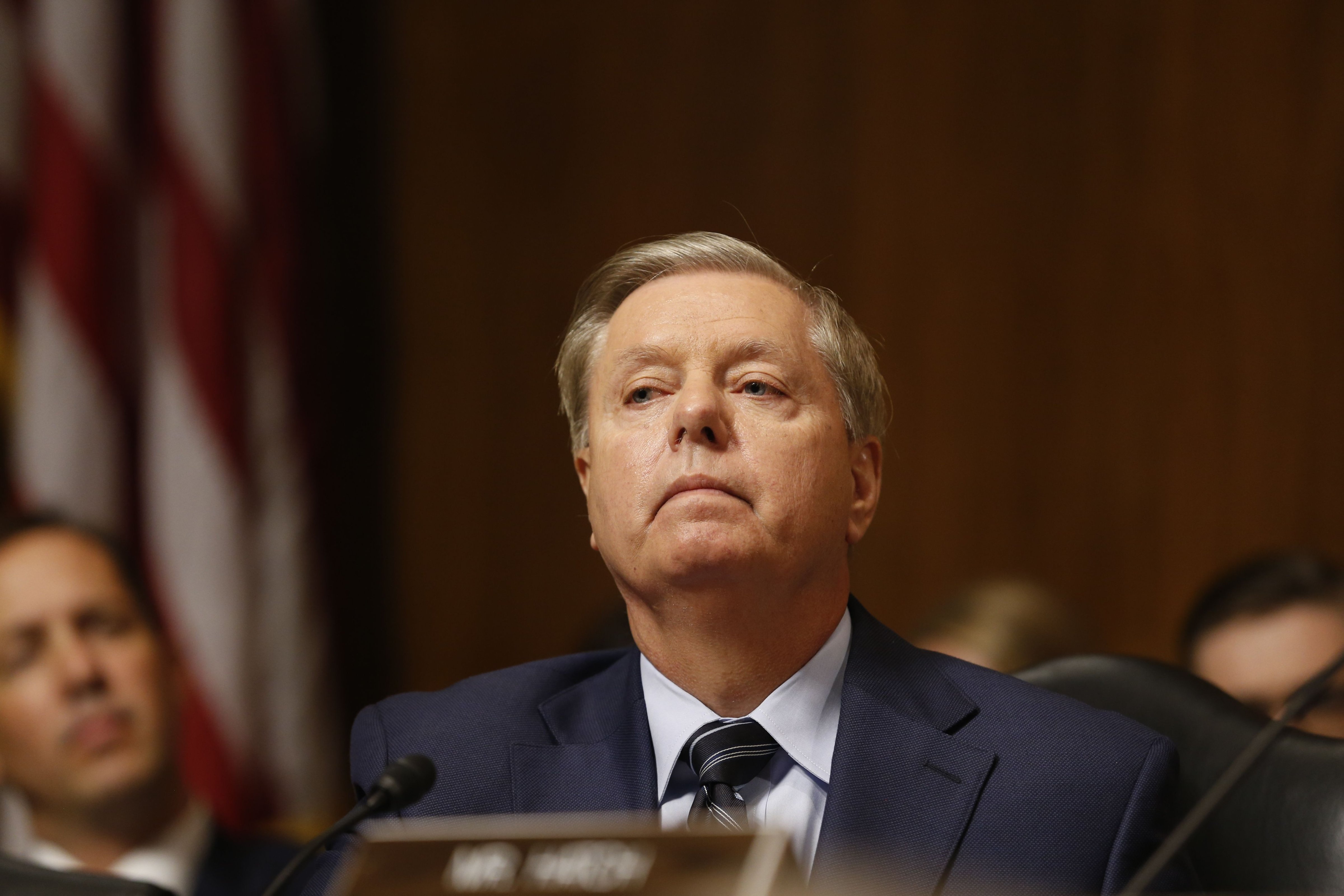 Senator Lindsey Graham (R-SC) listens to Dr. Christine Blasey Ford speak before the Senate Judiciary Committee hearing on the nomination of Brett Kavanaugh to be an associate justice of the Supreme Court of the United States, on Capitol Hill on Sept. 27. (Pool via CNP/REX/Shutterstock—Pool via CNP/REX/Shutterstock)