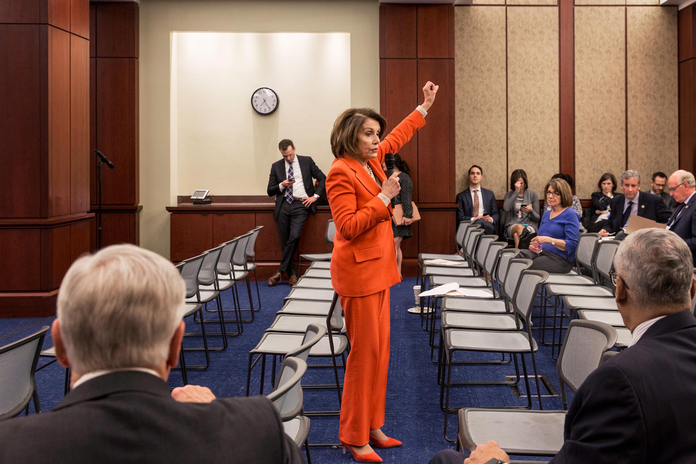 Pelosi addresses members of her caucus during a meeting in February
