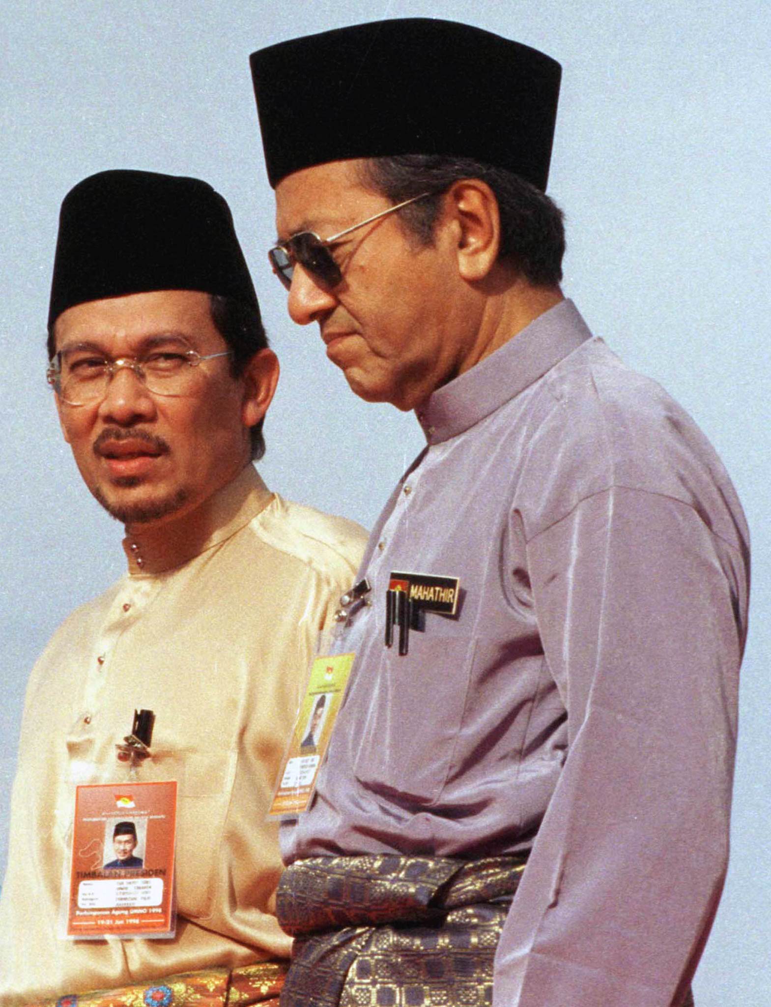 Malaysian Deputy Prime Minister Anwar Ibrahim (L) walks with Prime Minister Mahathir Mohamad in Kuala Lumpur on June 19, 1998. (David Loh—Reuters)