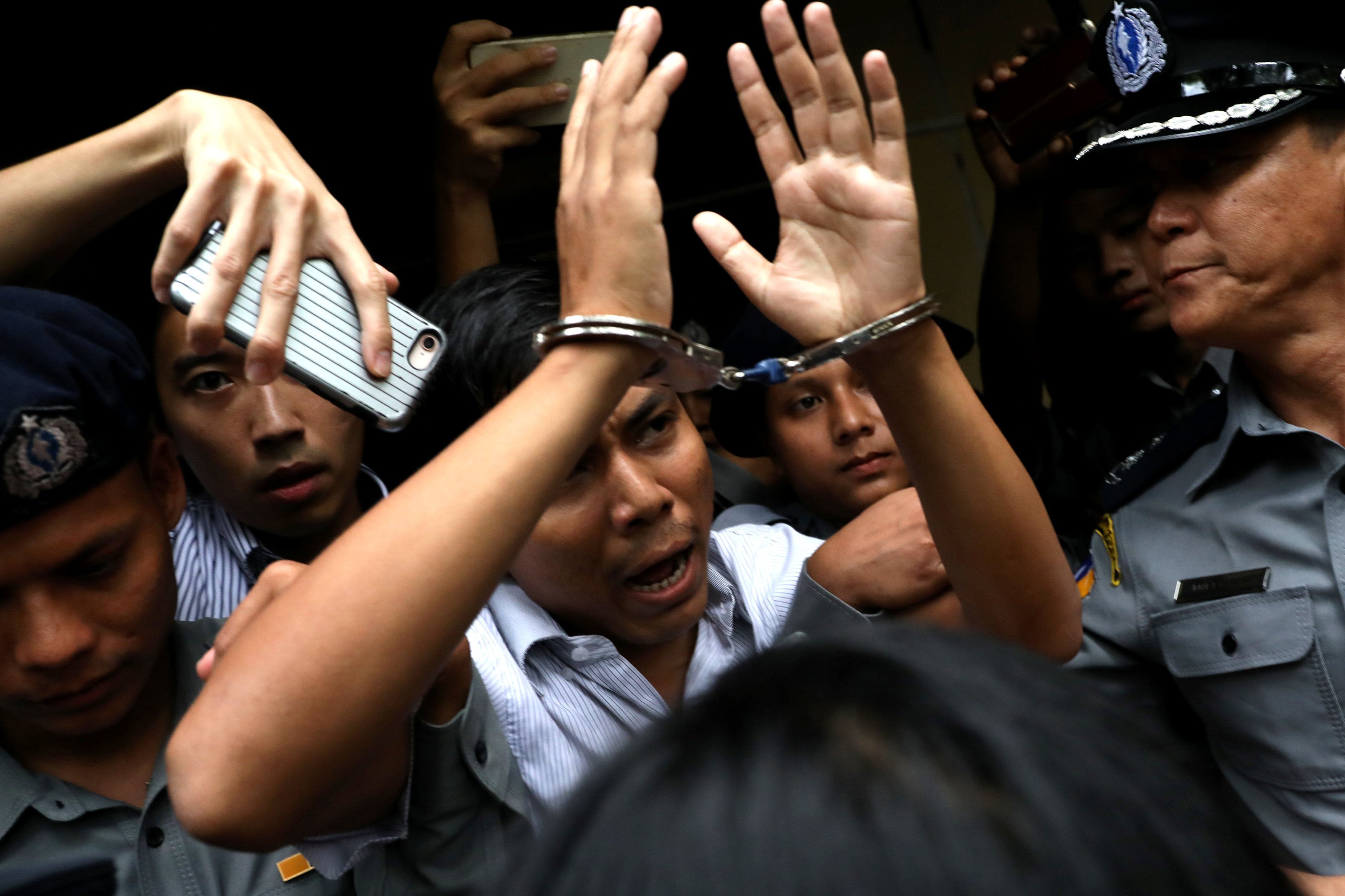 ournalist Kyaw Soe Oo is escorted from court after his verdict in Yangon, Myanmar on Sept. 3, 2018. (Ann Wang—Reuters J)