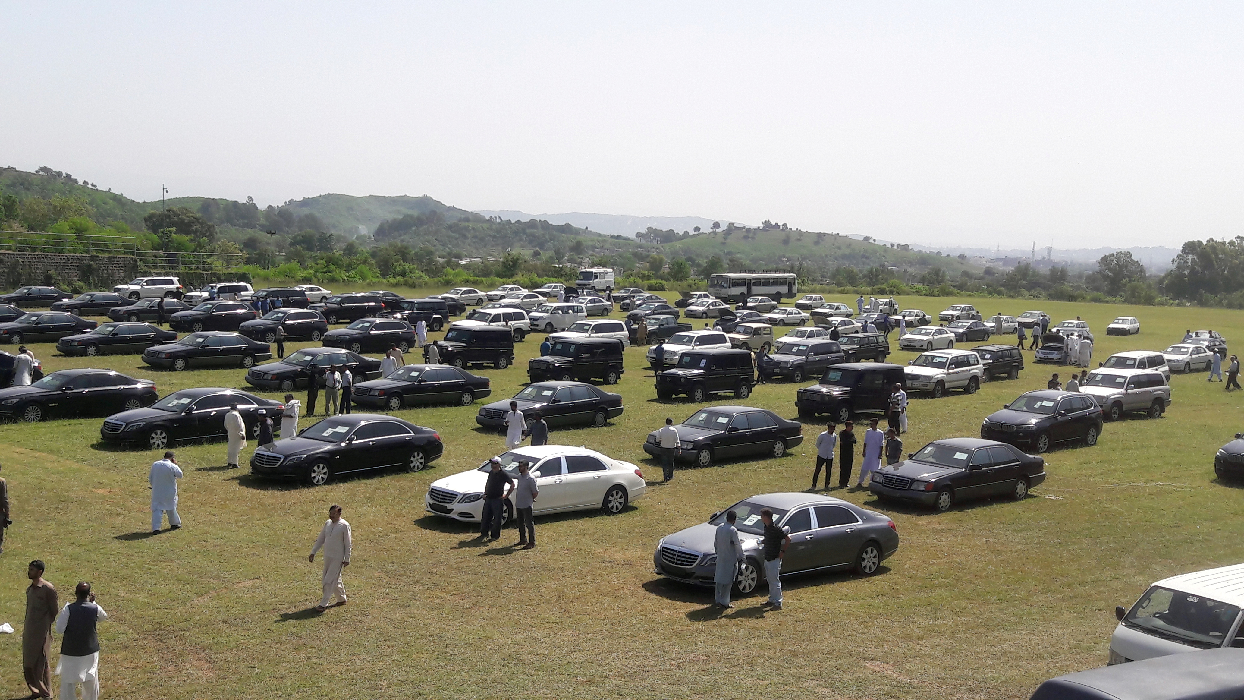 People visit an auction of government owned used cars at the premises of Prime Minister House in Islamabad, Pakistan on Sept. 17, 2018. (Faisal Mahmood—Reuters)