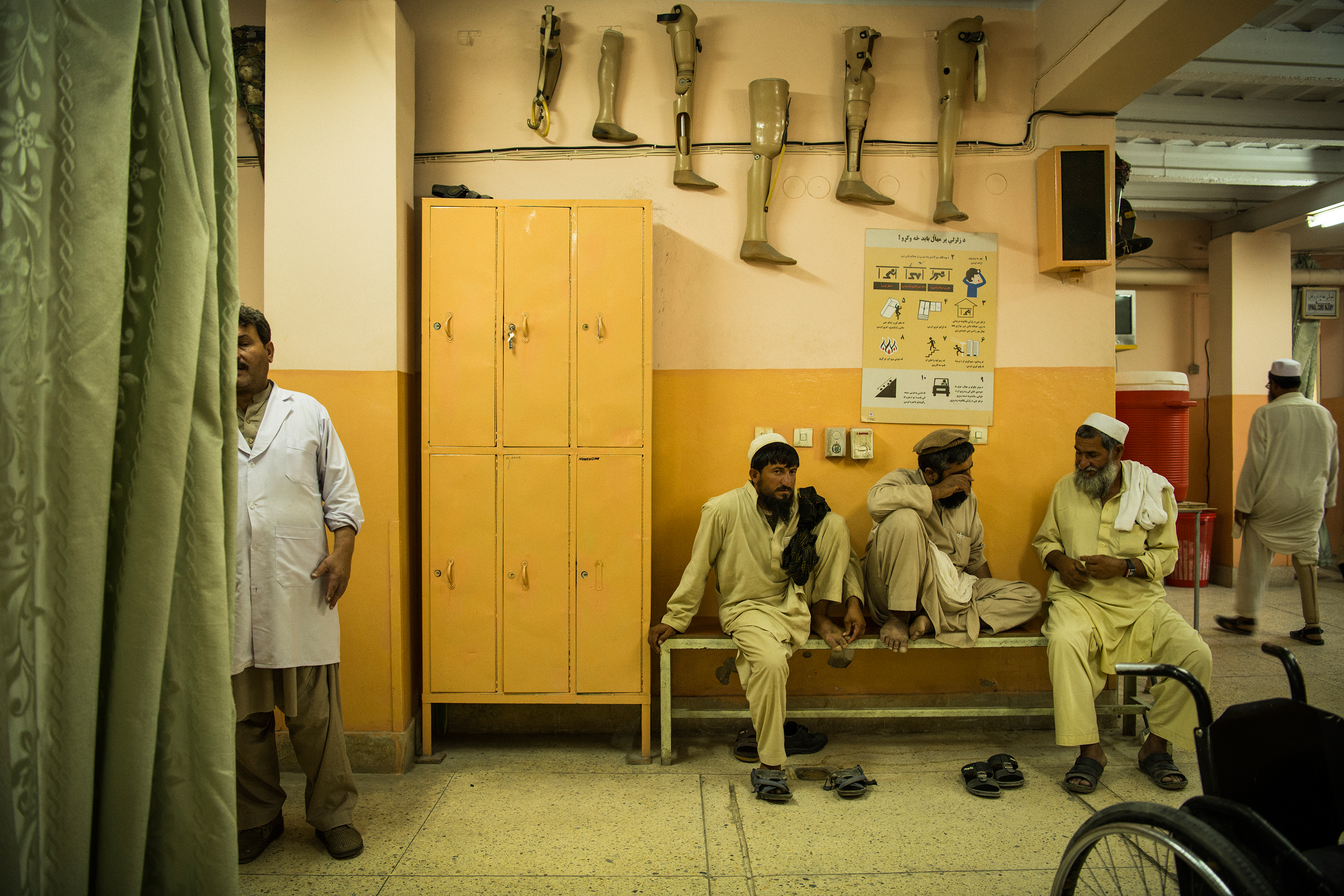 Hamisha Gul, right, at the orthopedic center in Jalalabad on June 27. In the center is Mohammad Hanif, Aman's father. (Andrew Quilty for TIME)