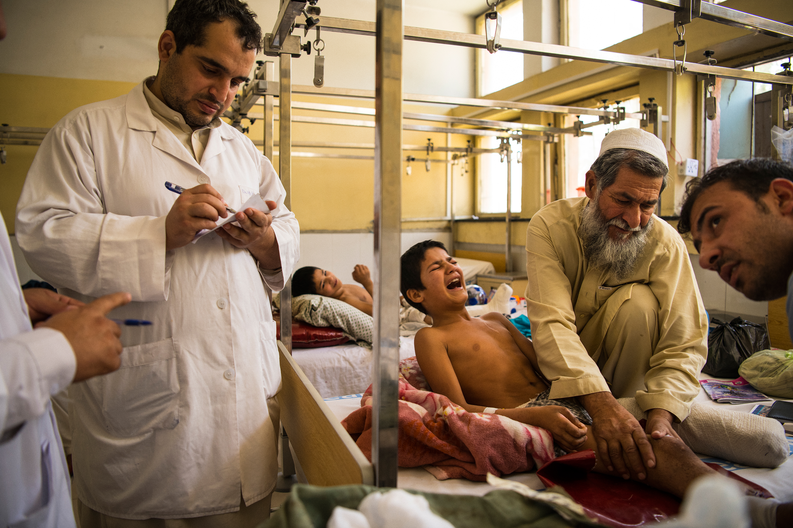 Abdul Rashid's wounds are cleaned, drained and redressed prior to he and his brothers' discharge from Nangarhar Regional Hospital after a month-long stay. (Andrew Quilty for TIME)