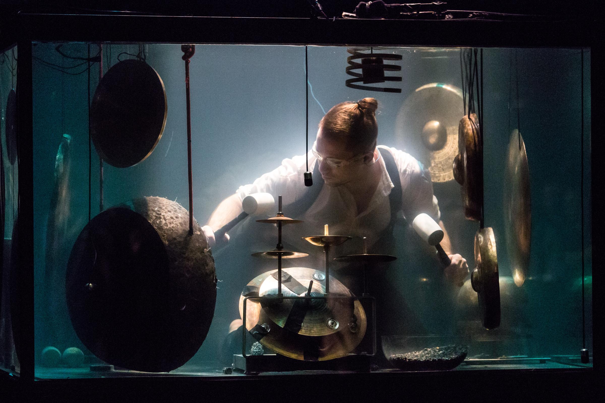 Drummer Morten Poulsen perform underwater ahead of their concert at Hong Kong's New Vision Arts Festival. / Photo by Aria Hangyu Chen for TIME.