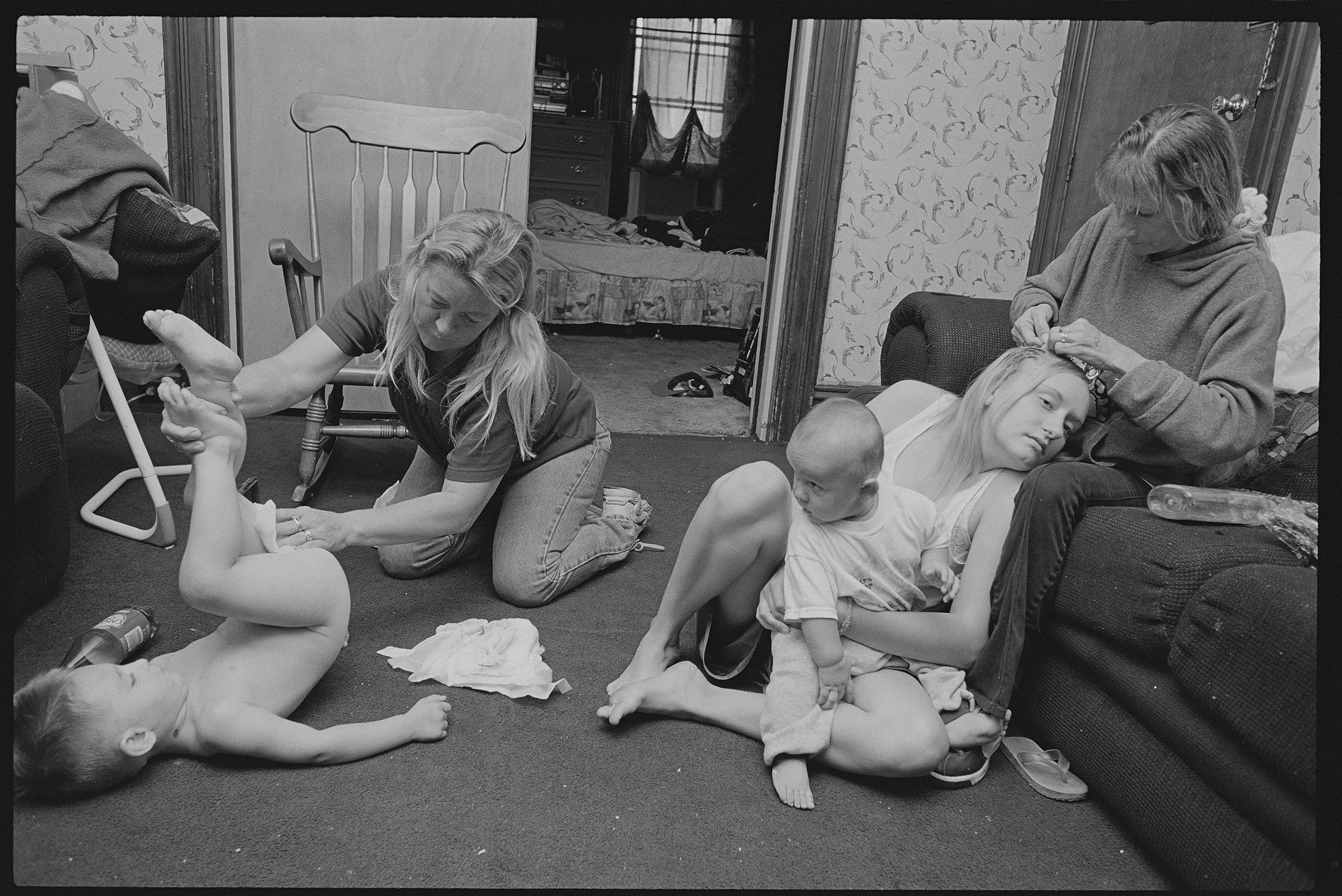 Tony watches 'Nanny Rose' Hill change his uncle Little Jesse’s diaper while Deb Stocklas braids her daughter Kayla’s hair in 2004. "Little Jesse and Tony were born less than two years apart and have always competed for the attention that comes with being the baby of the family," says Kenneally. (Brenda Ann Kenneally)