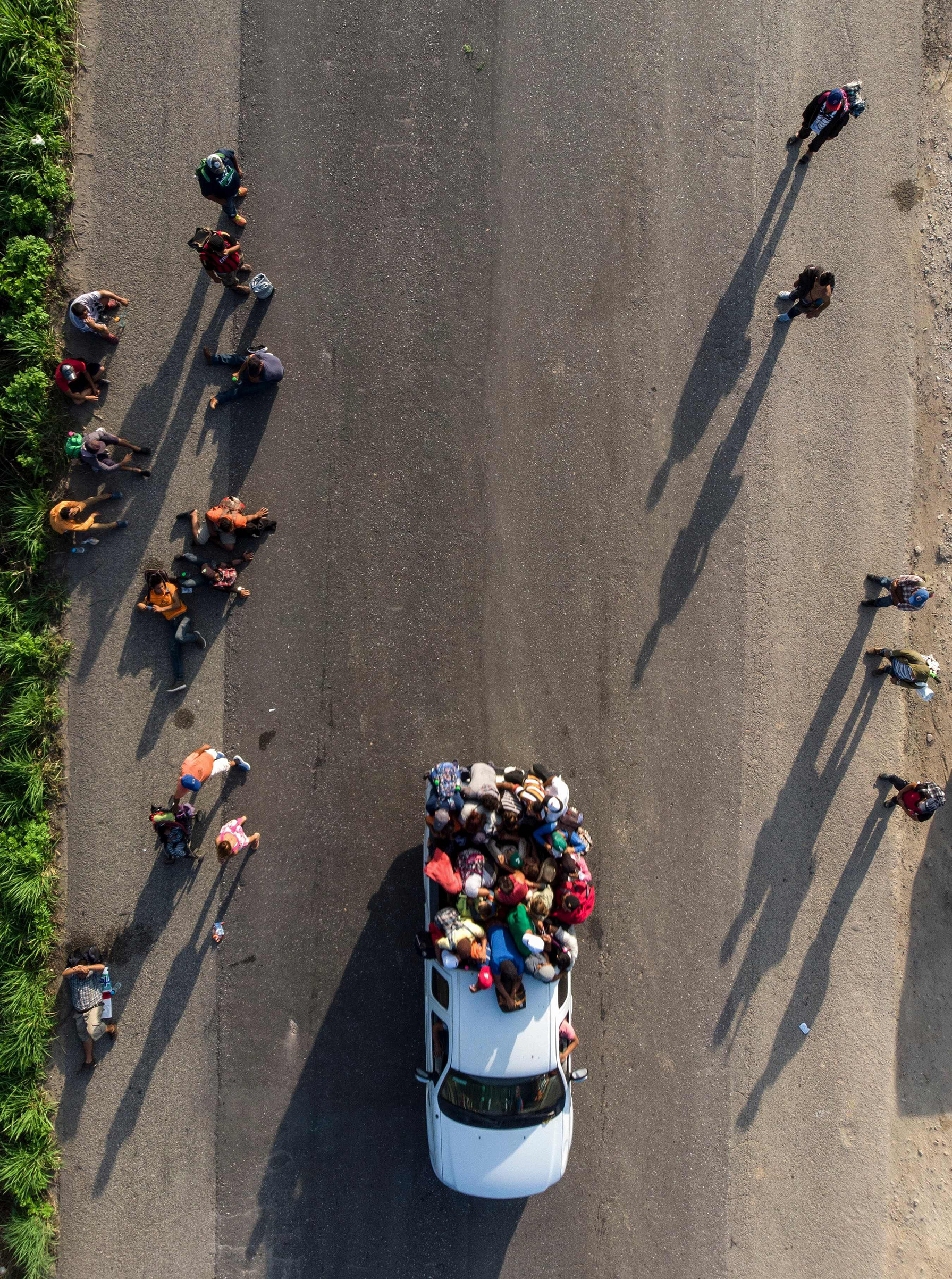 Honduran migrants, part of a caravan to the U.S., resume their march in Oaxaca State, Mexico, on Oct. 29