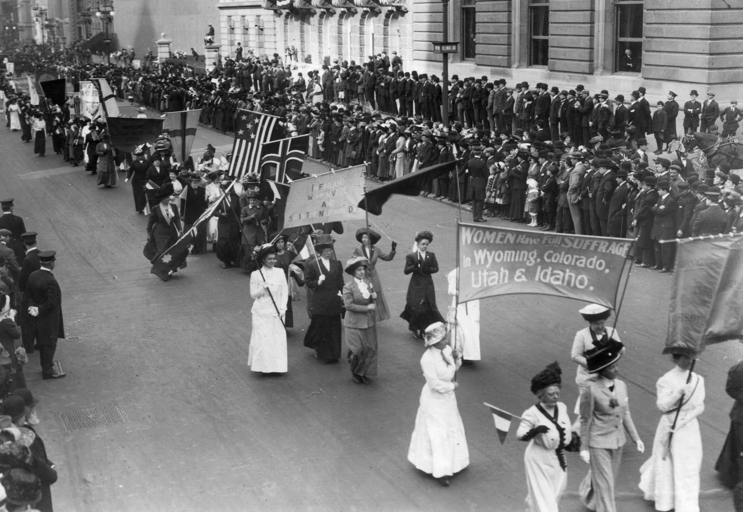 Suffragettes carrying a banner announcing that 'Women have full suffrage in Wyoming, Colorado, Utah and Idaho' at the Women of all Nations Parade in New York on May 3, 1916 (Paul Thompson—Getty Images)