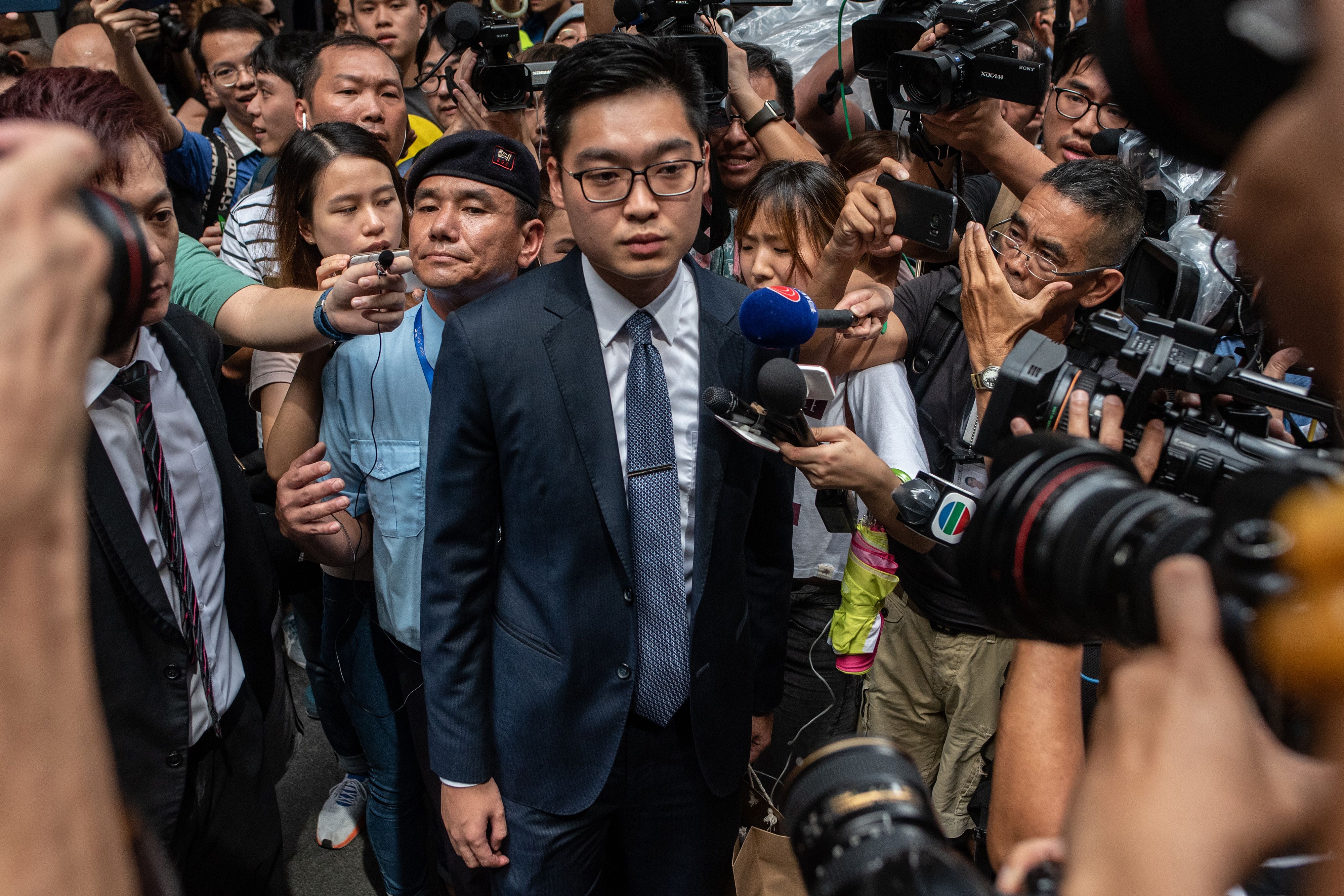Andy Chan (C), founder of the Hong Kong National Party, is surrounded by members of the media as he leaves the Foreign Correspondents' Club in Hong Kong on Aug. 14, 2018. (Philip Fong—AFP/Getty Images)
