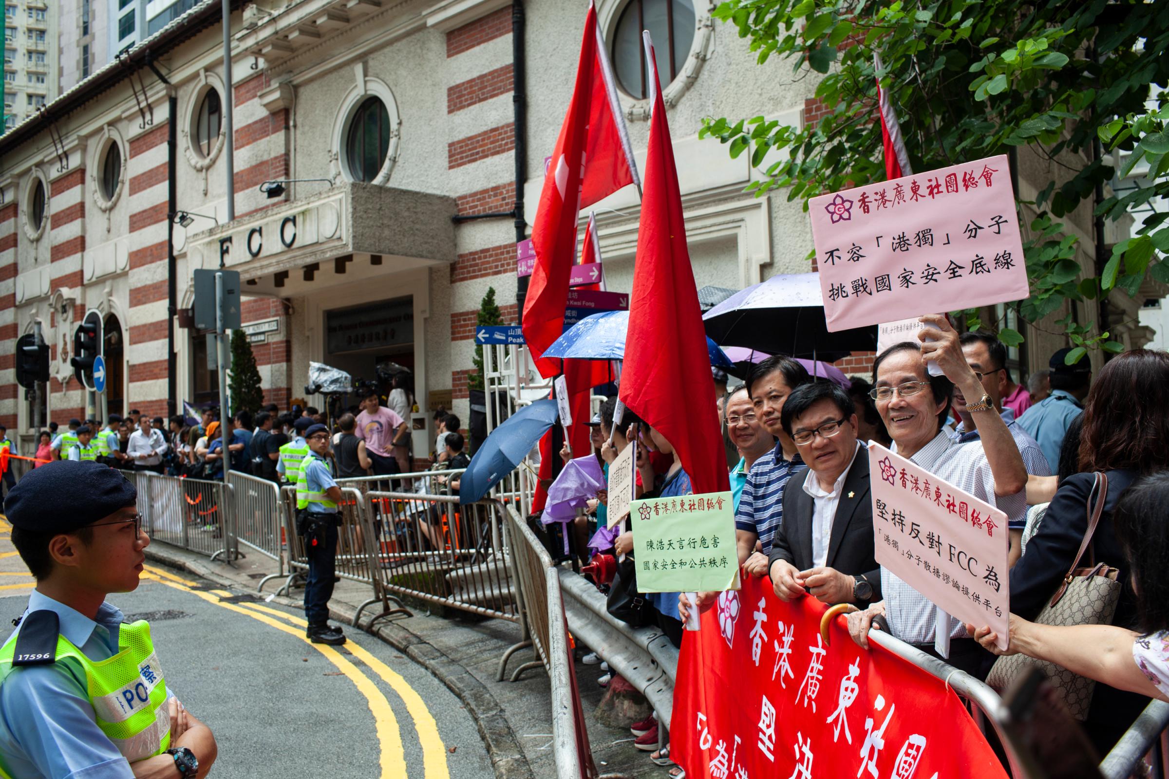 Pro-China demonstrators holding signs that read, Hong