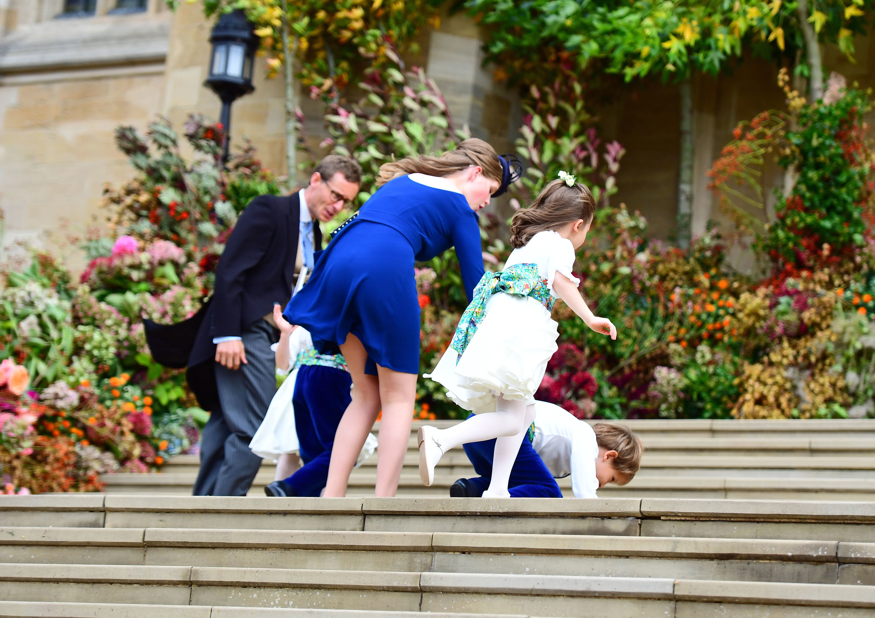 OCT 12: Pageboy Louis de Givenchy falls on the West Steps, as the bridesmaids and page boys arrive to attend the wedding of Princess Eugenie (VICTORIA JONES—AFP/Getty Images)