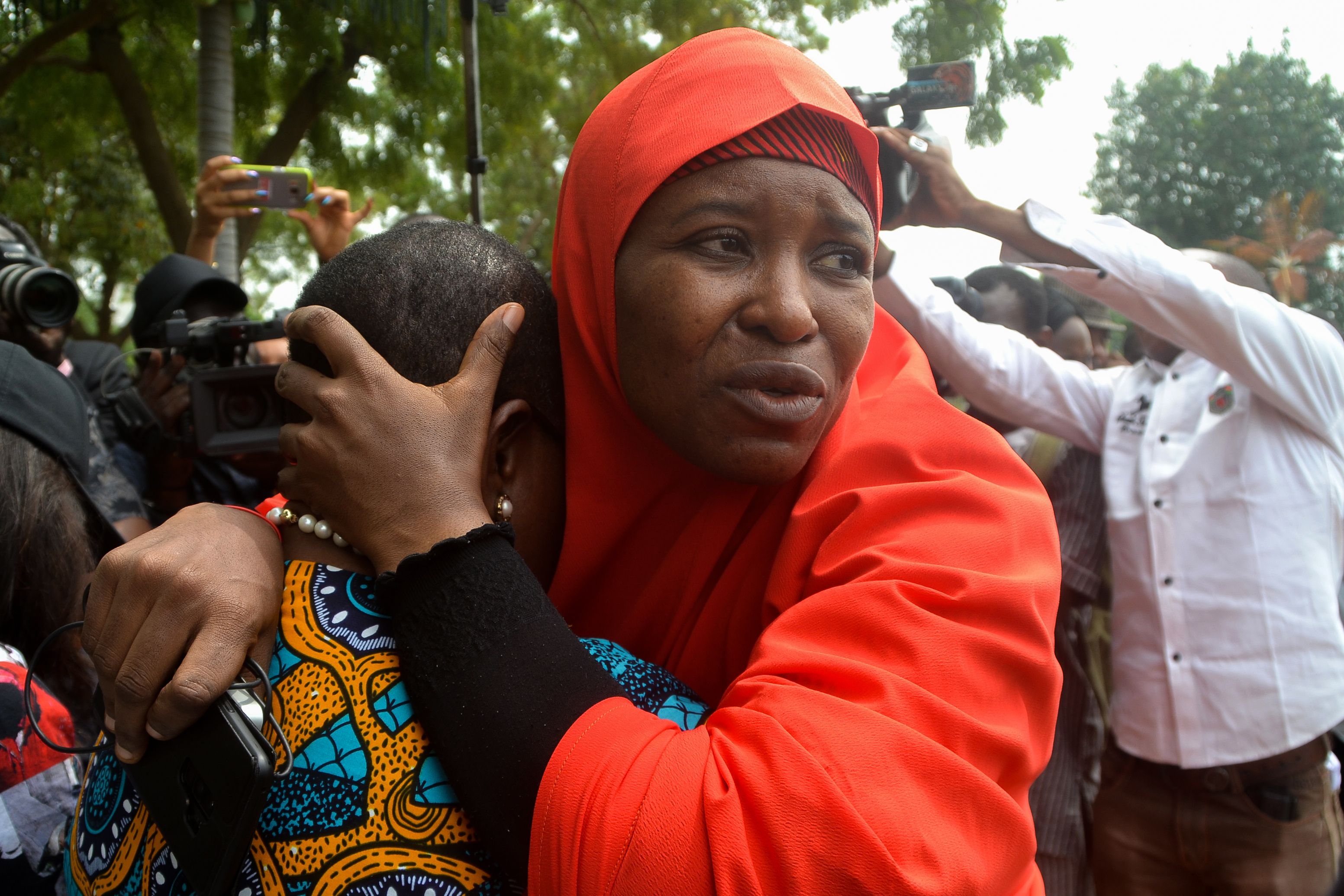 Founder of the Bring Back Our Girls (BBOG) advocacy group Oby Ezekwesili is comforted during a protest in Abuja, Nigeria on Oct. 16, 2018, following the killing of a kidnapped female Red Cross worker by Islamic State-allied Boko Haram jihadists. (Mudashiru Atanda—AFP/Getty Images)