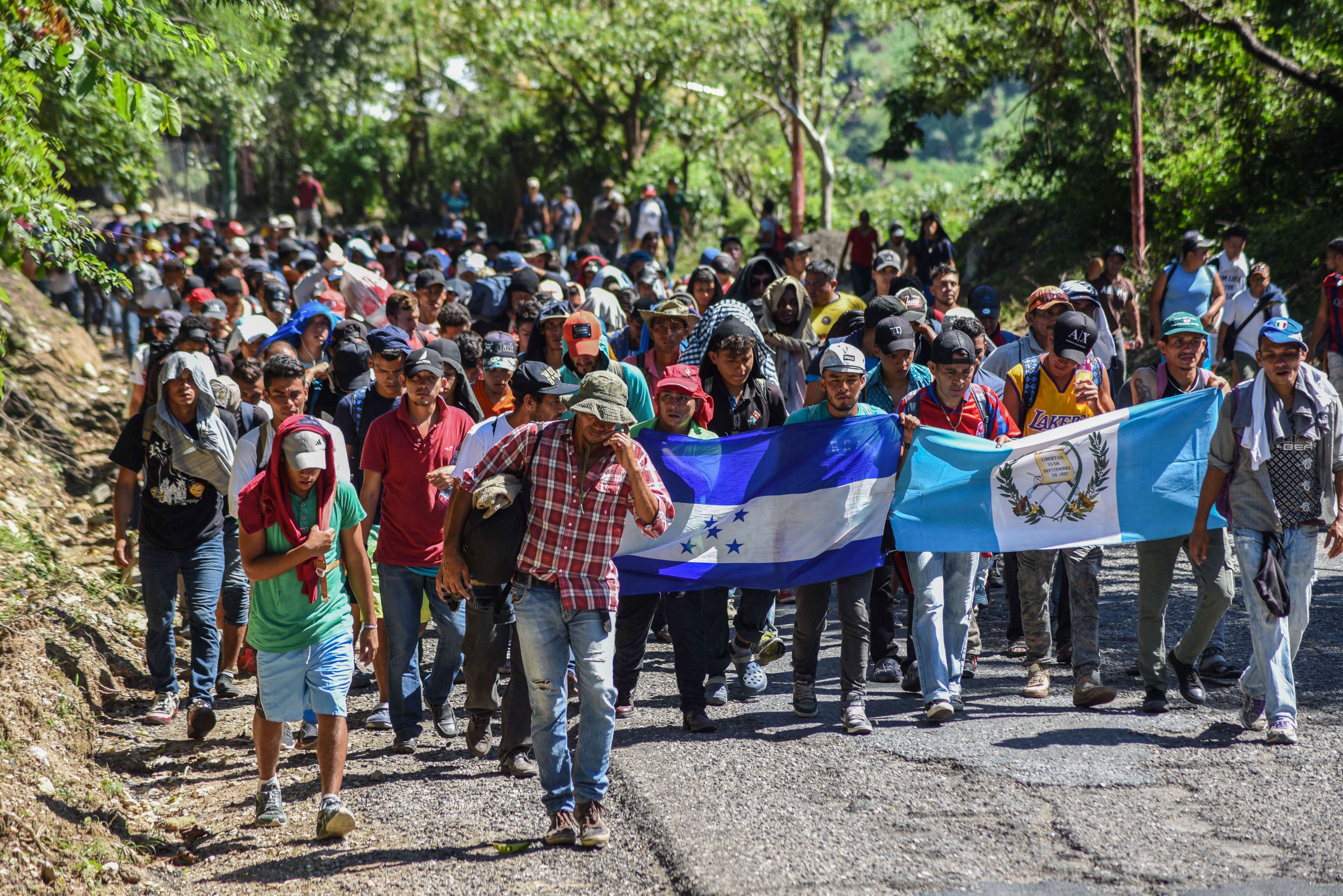 OCT 22: Honduran migrants take part in a new caravan heading to the US with Honduran and Guatemalan national flags in Quezaltepeque, Chiquimula, Guatemala (ORLANDO ESTRADA&mdash;AFP/Getty Images)