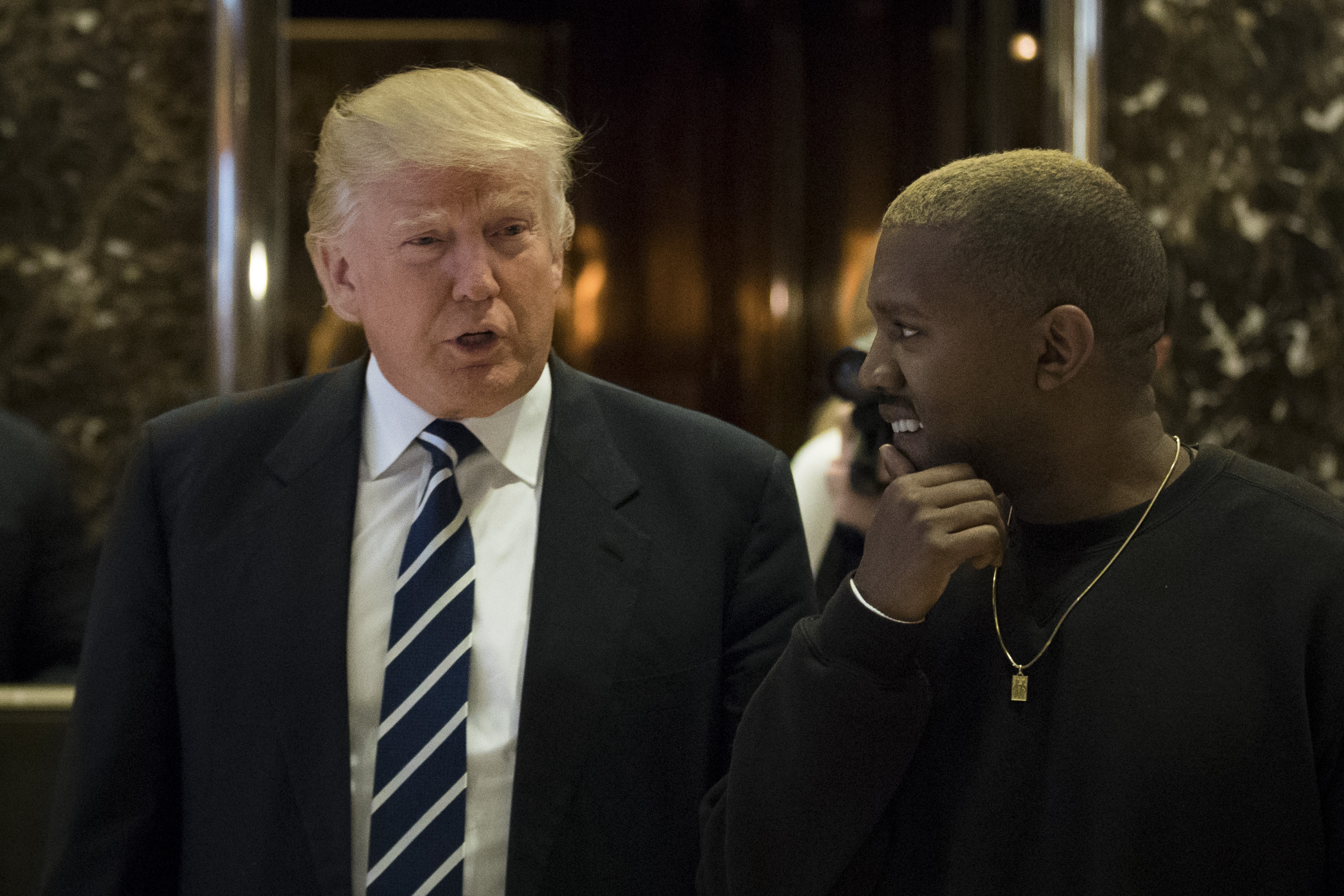President-elect Donald Trump and Kanye West walk into the lobby at Trump Tower, December 13, 2016 in New York City. (Drew Angerer/Getty Images)