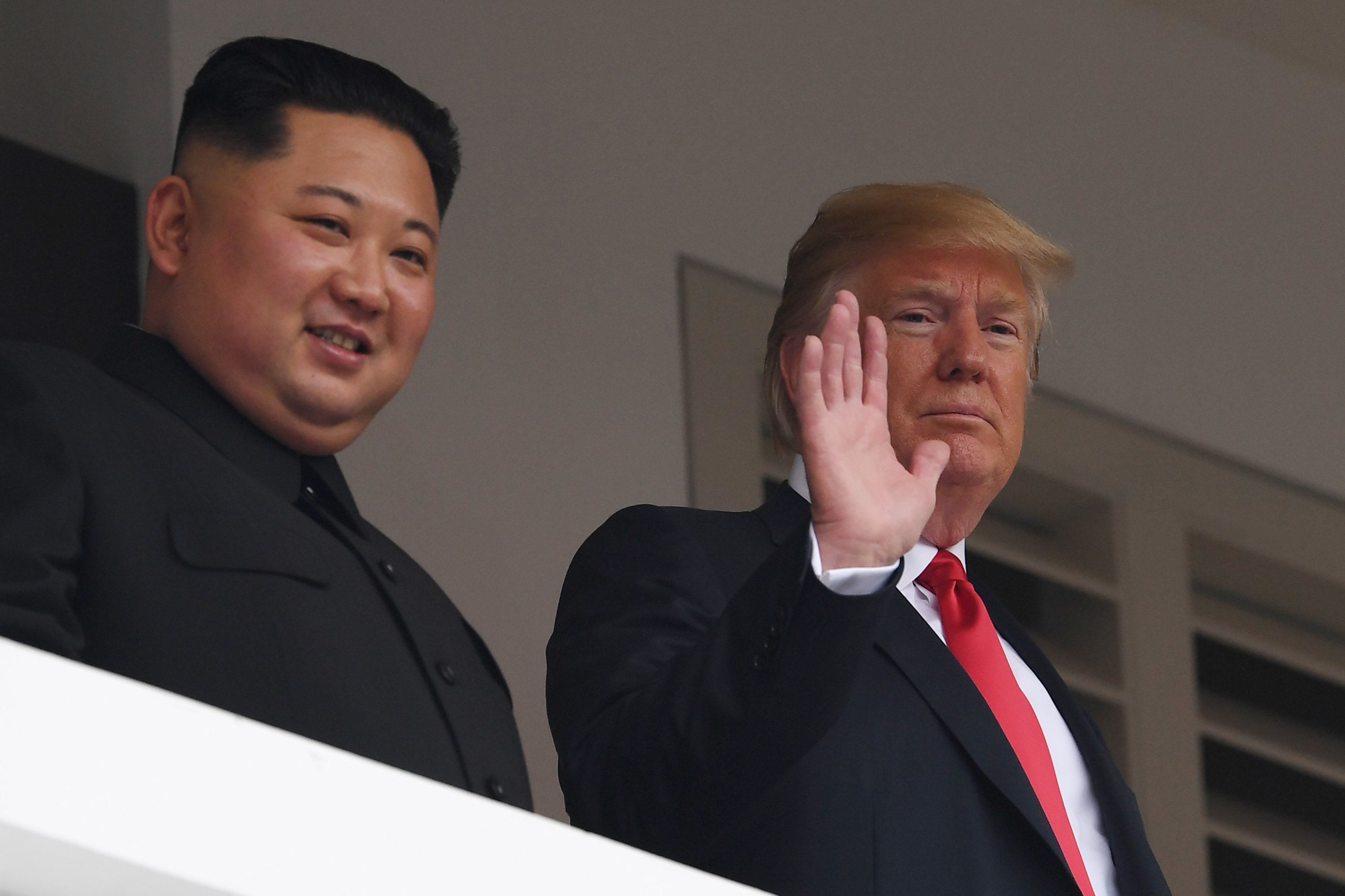 June 12: US President Donald Trump waves as he and North Korea's leader Kim Jong Un look on from a veranda during their historic US-North Korea summit in Singapore (Saul Loeb&mdash;AFP/Getty Images)