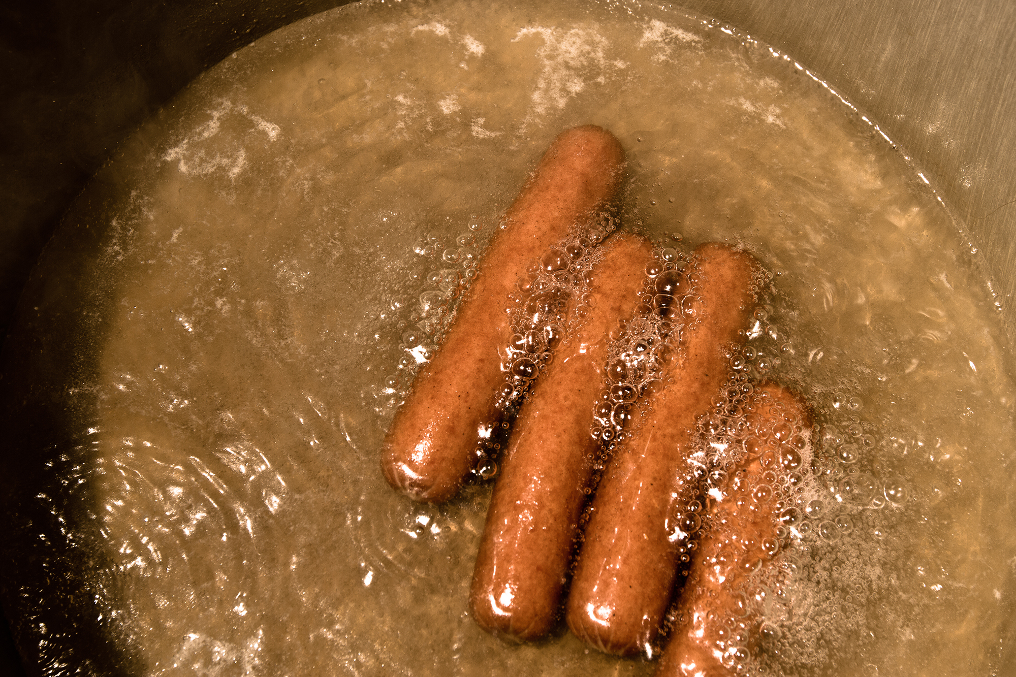 Hotdogs cooking in water