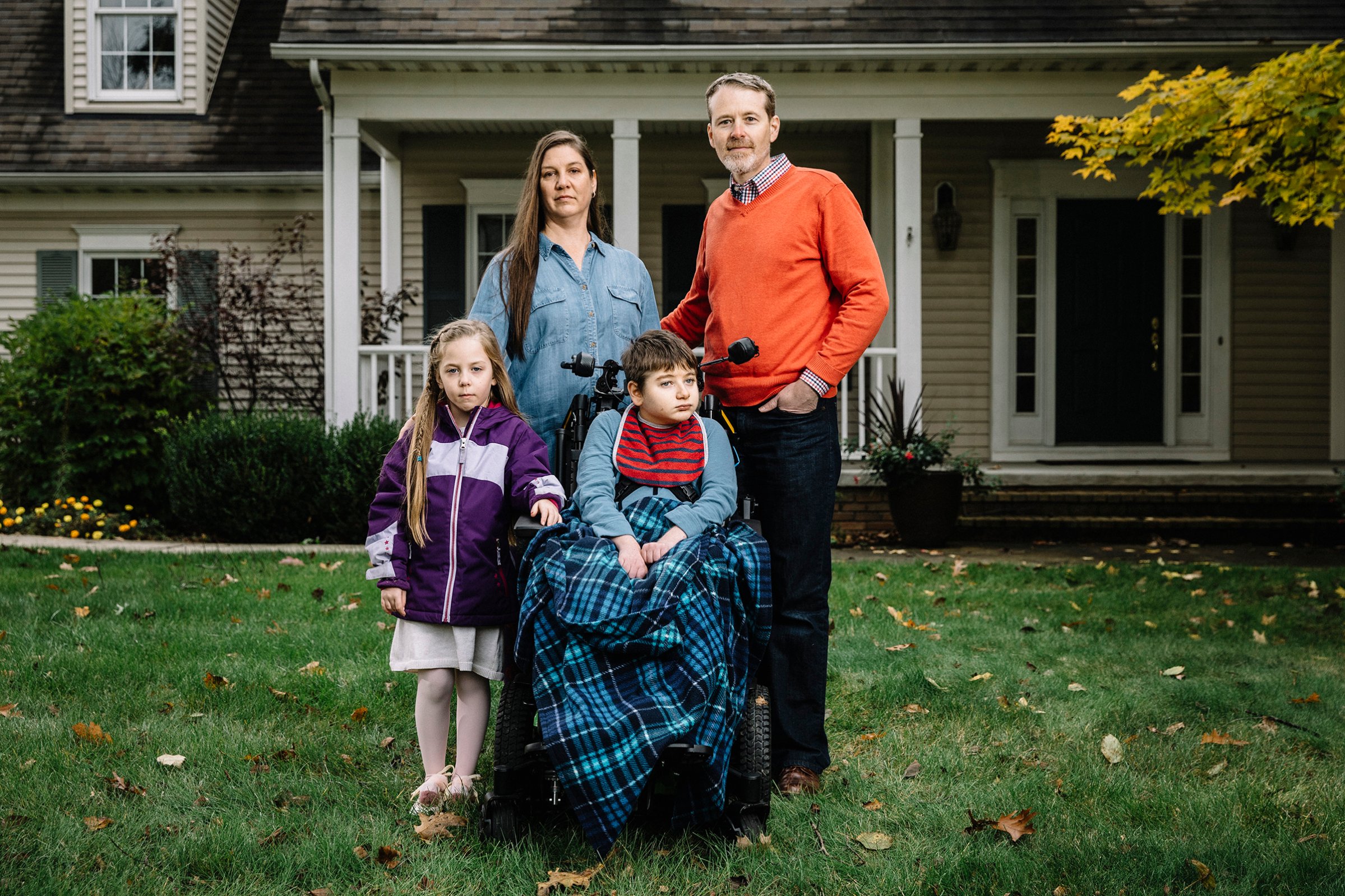 Christine and Larry Callahan, with kids Claire, 5, and Andrew, 11, in front of their home in Cleveland’s northeast suburbs