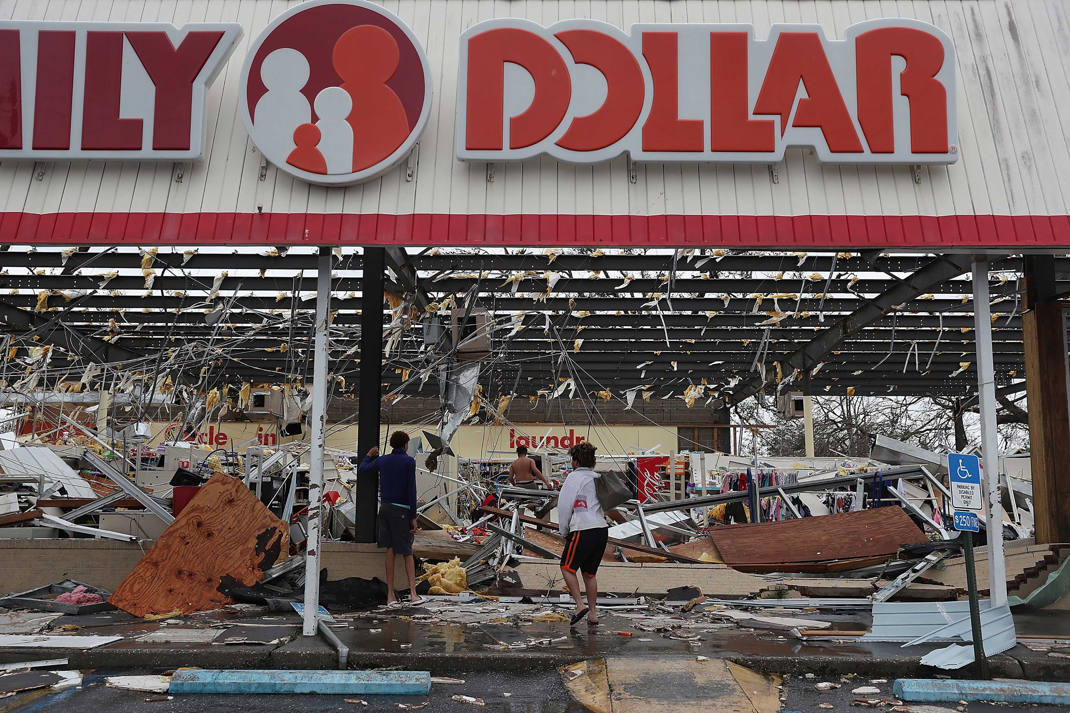 People look on at a damaged store after Hurricane Michael passed through on Oct. 10, 2018 in Panama City, Fla. (Joe Raedle—Getty Images)