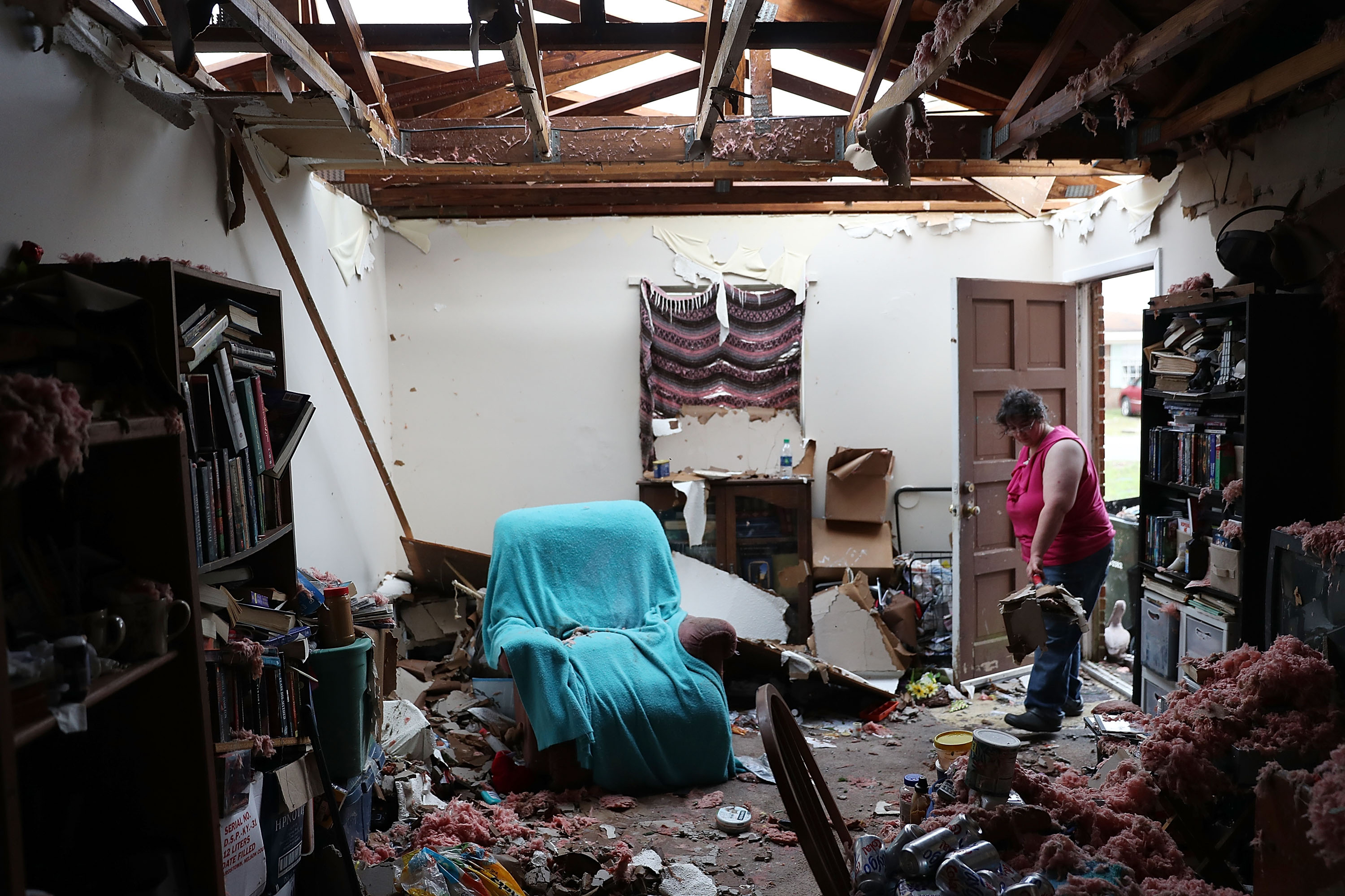 Amanda Logsdon begins the process of trying to clean up her home after the roof was blown off by the passing winds of Hurricane Michael on Oct. 11, 2018 in Panama City, Fla. (Joe Raedle—Getty Images)