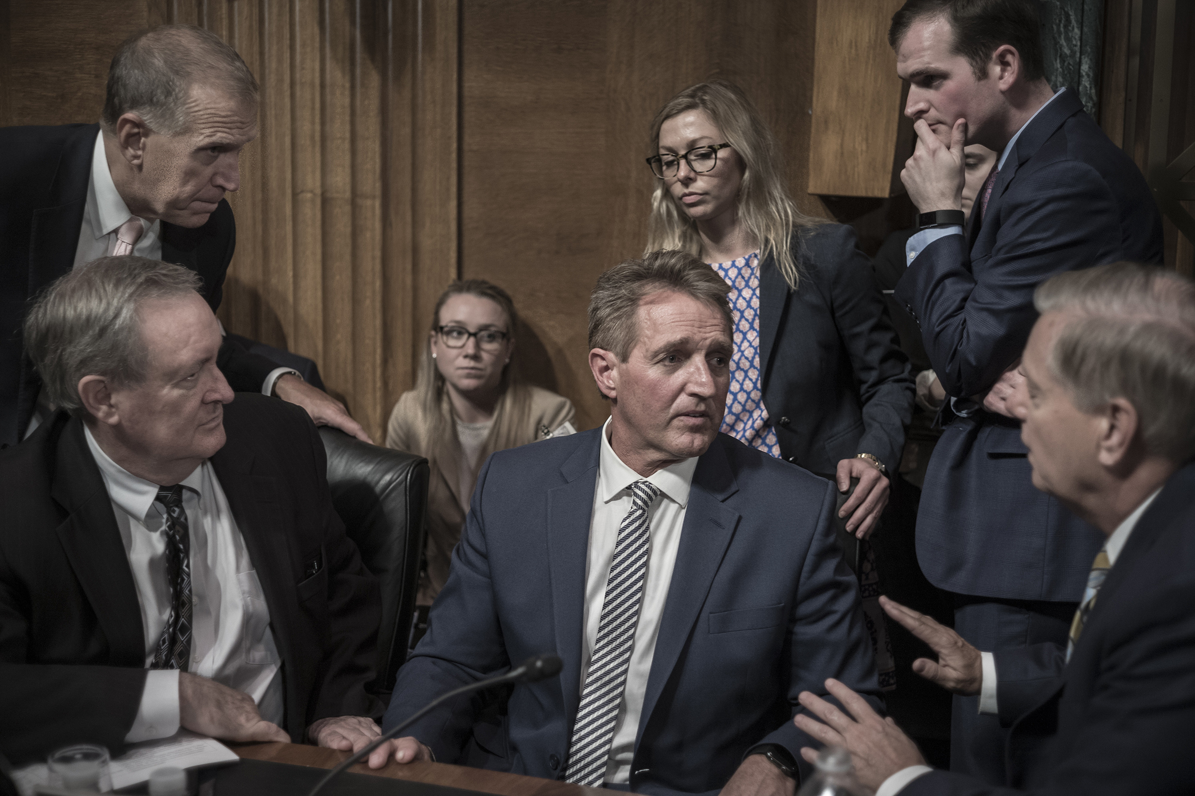 GOP Senators surround Senator Jeff Flake, who slowed Kavanaugh’s confirmation after Ford testified (David Butow—Redux for TIME)