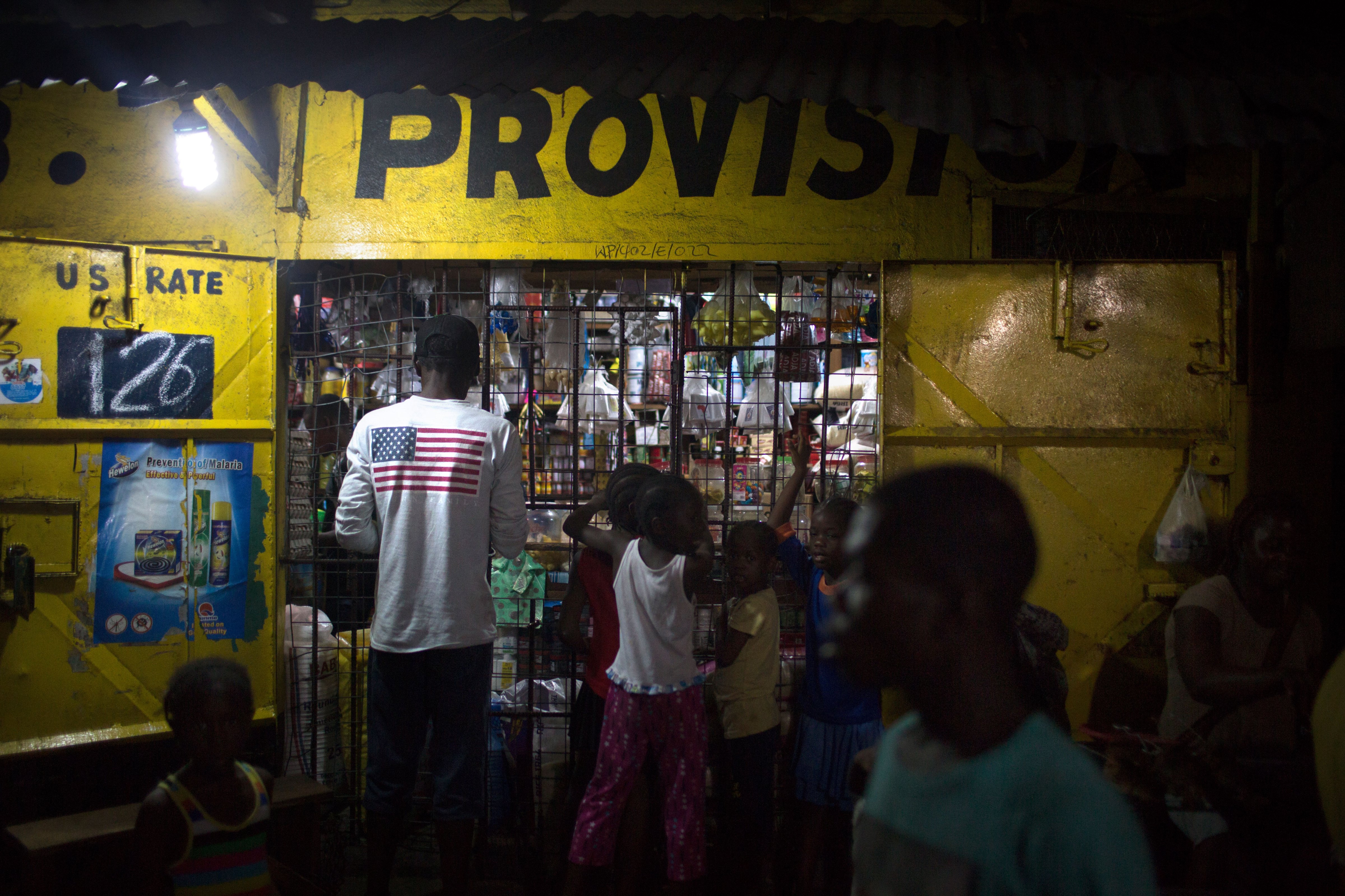 Patrons line up at a shop in the West Point community of Liberia's capital. More Than Me was created to educate girls who are from this community, many of whom are at risk of sexual exploitation. (Kathleen Flynn, special to ProPublica)